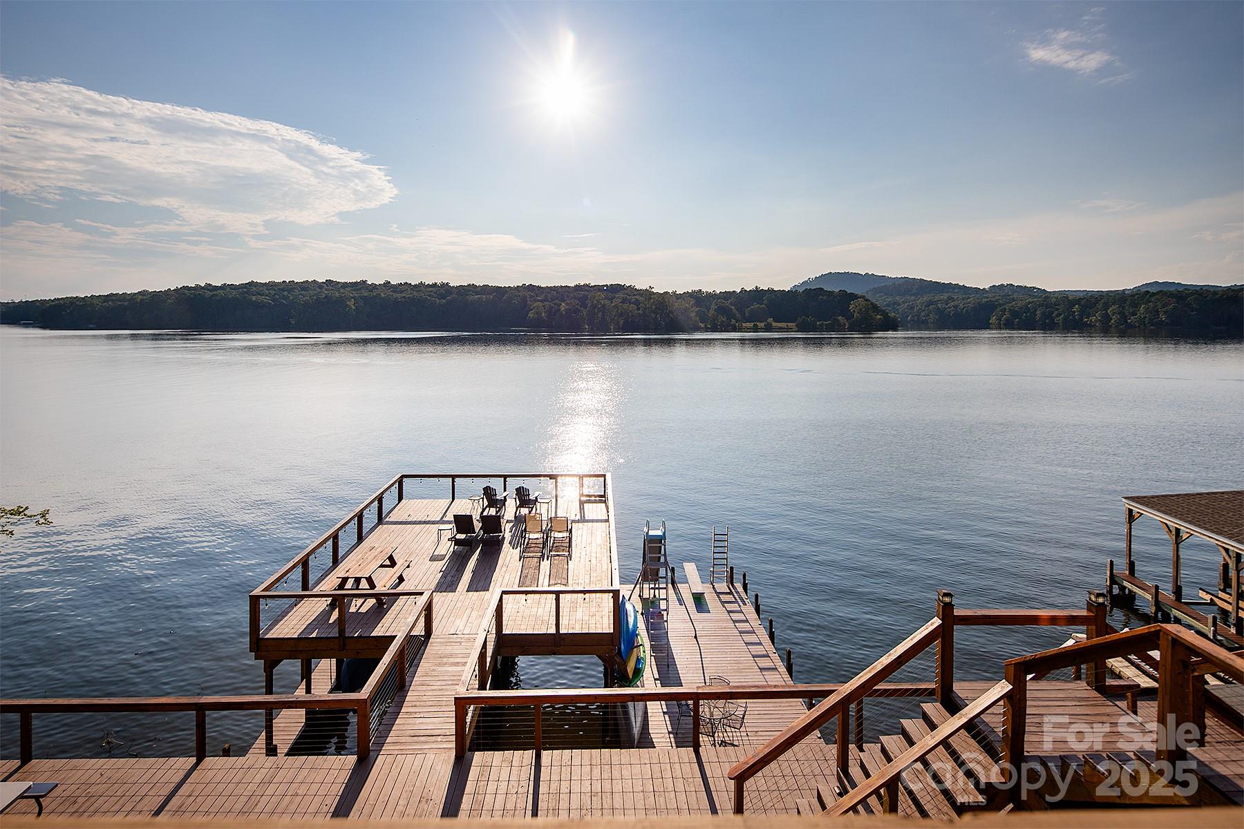 Soak in one of the BIGGEST views on Lake Tillery, front-row to Morrow Mountain State Park! This stunning Holiday Shores retreat offers deep-water living at its finest, complete with a fully furnished, short-term rental–ready home. Enjoy endless lake days from your massive 2-stall boathouse with a large sundeck or relax on the screened porch overlooking the water! Inside, you’ll find wonderful upgrades throughout! Main level holds the primary bedroom & bathroom, 2 additional bedrooms, cozy living room and kitchen with breathtaking water views! Venture upstairs to find a large recreation room with a half bathroom! The basement provides a den, bonus room and an amazing home gym! Ample parking is no problem with a community parking lot across the street and an extra graveled septic lot perfect for guests. Whether you’re looking for your forever lake home or a turnkey investment, this property delivers big views, big water, and big opportunities!