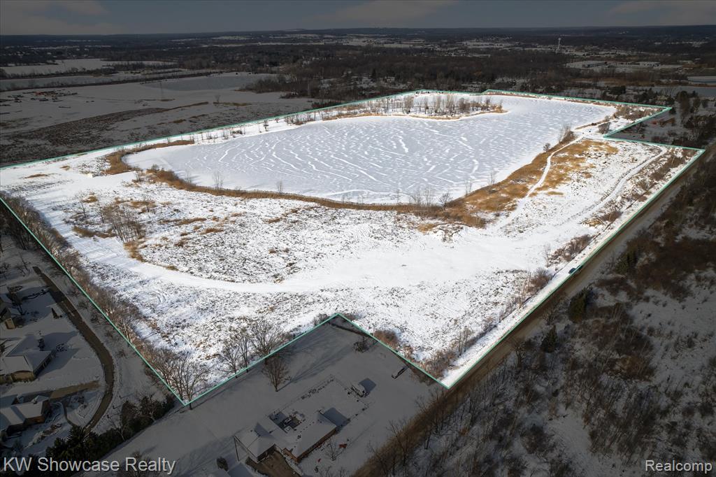 Extraordinary All-Sports Lakefront Estate Opportunity | 90.43 Acres | Lyon Township. An exceptionally rare offering in Lyon Township, this breathtaking residential lakefront parcel presents the perfect canvas for a private, estate-style retreat. With an entire lake and thousands of feet of lake frontage, on an all-sports lake, the property delivers panoramic water views, unmatched privacy, and direct access to water skiing, boating, and year-round lake recreation. The land is level and build-ready, ideally suited for a custom +/- 4,000-5,000 square foot luxury residence, with ample room for outdoor living spaces designed to capture the serene lake setting. With no HOA restrictions, this property provides true freedom of ownership—an increasingly rare advantage in a luxury lakefront setting. Whether envisioned as a full-time residence or a generational estate, the scale, frontage, and setting combine to create a once-in-a-lifetime opportunity. Secluded yet conveniently located, this premier 90.43 acre parcel offers the ultimate blend of privacy, lifestyle, and long-term value in one of the area’s most desirable communities. The lake is spring fed and ranges from 35'-40' deep. Buyer must use Seller's designated Builder, Paul Elkow Building Company. Additional MLS Listing with proposed home and video will be forthcoming. Please book any viewing through Showing Time. Access details to be provided.