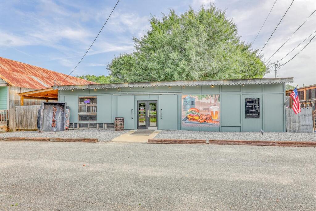 Rare opportunity to own one of downtown Boston, Georgia's most unique restaurant, catering, and social destinations! This offering includes the LAND, BUILDING, BUSINESS, and extensive FF&E, creating an exceptional opportunity to acquire the real estate along with an established operation and much of what is needed to continue the concept.  The Silo 31626 is more than a place to grab a bite—it is a fun, relaxed gathering spot where families bring the kids, friends meet for dinner and drinks, couples enjoy an evening out, and groups come together to celebrate, socialize, and enjoy the atmosphere.  Located in the heart of downtown Boston on a 5,652-square-foot lot directly across from the city park and stage, The Silo enjoys a wonderful setting near downtown shops and businesses with plenty of convenient parking nearby. Boston hosts numerous community events and activities throughout the year, adding to the appeal of this downtown location and making The Silo a natural gathering place before, during, and after local events.  The property offers a distinctive indoor/outdoor concept with multiple spaces for dining, entertaining, private gatherings, catering, and live entertainment. String lights, outdoor seating, custom swings, picnic tables, covered patio, and the grain bin stage area create a casual atmosphere that invites guests to come, relax, and stay awhile. Whether it's a family outing, date night, friends getting together, birthday celebration, or larger group event, The Silo offers something special—a place where the experience is just as important as the food.  Currently permitted as a food truck with base of operations/catering, the property features a large indoor prep area with commercial equipment, multiple sinks, ADA-compliant restroom, and indoor bar seating. A major highlight is the approximately 1,170-square-foot, three-section covered and concreted patio with fans, lighting, and a bar counter added in 2025. The patio can be divided into sections, providing opportunities for private parties, showers, receptions, reunions, business gatherings, and other events.  The large fenced picnic area features front and rear cattle gates and string lighting. A grain bin with stage area provides a natural focal point for live music and entertainment, while a large concrete area accommodates the current food truck operation.  An extensive collection of furniture, fixtures, and equipment is included. Commercial equipment includes coolers and freezer, four-head kegerator, 300-lb. ice maker, beverage refrigeration, stainless-steel prep tables, convection ovens, panini press, food warmer, soup kettle, sinks, shelving, tables, bar stools, picnic tables, indoor/outdoor chairs, outdoor heaters, custom swings, kitchen equipment, serving pieces, and extensive catering equipment.  Operational for four years as of May 2026, the owner reports average sales of approximately $250,000 plus approximately $25,000 in average catering sales, while operating on a limited schedule of Thursday, Friday, and Saturday from 4-9 PM and Sunday from 10 AM-3 PM. This limited schedule may offer a new owner opportunities to explore expanded hours, additional catering, private events, live entertainment, and other revenue streams.  The food truck is included in the list price, but may also be purchased separately or rented.  This is not simply a business for sale—the offering includes the land, building, established business, and extensive FF&E. Whether continuing The Silo 31626 or bringing a new vision, this is an opportunity to own a downtown destination designed for people to gather, eat, laugh, celebrate, and make memories in the heart of charming Boston, Georgia.