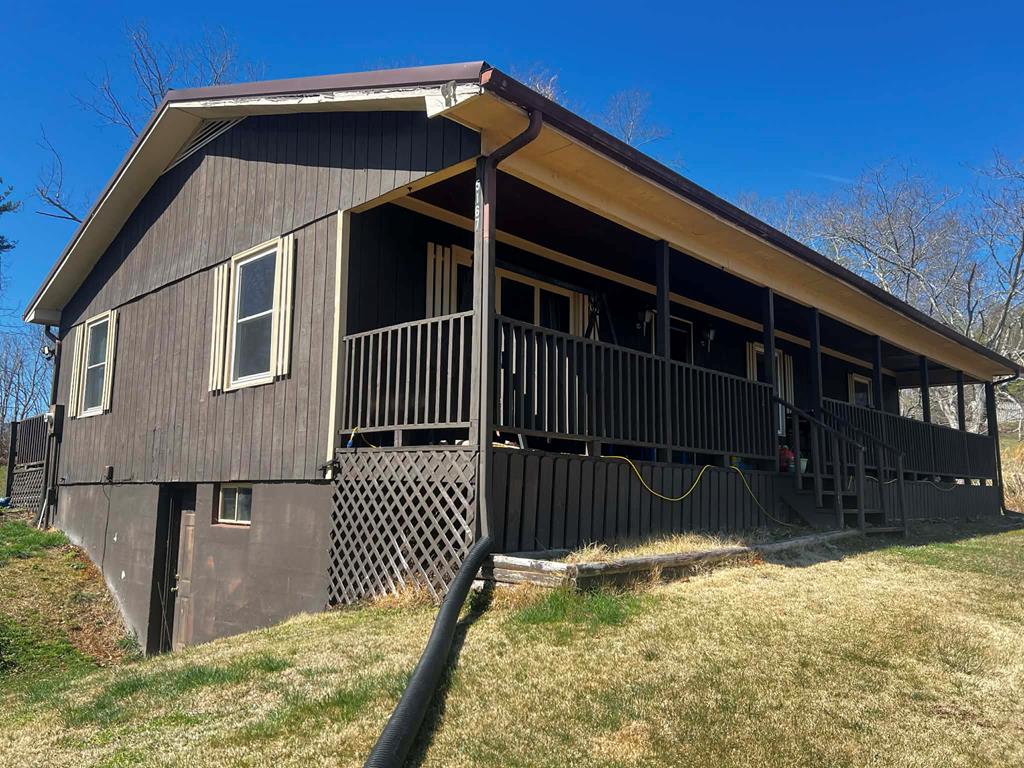 This 3-bedroom, 2-bath home offers mountain views, privacy, and a peaceful setting. The property backs directly up to the Jefferson National Forest, providing direct access to nature and endless outdoor opportunities right from your backyard. Features include a paved driveway, metal 2-car carport, covered front porch, and a large back deck. Enjoy mountain views from both the front and back of the home. The full basement offers extra space for storage or future use and includes a flue for the option to add a woodstove. Conveniently located with an easy commute to Fries and Galax, and just minutes from the New River and Fries Dam, this property is ideal for a full-time residence or a mountain getaway.