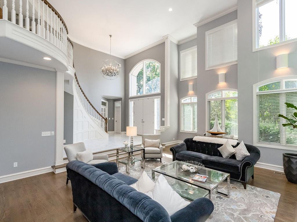 Nestled on a private 1.6 acre lot in the back of a quiet cul de sac, this move in ready home offers a luxurious lifestyle with abundant space and thoughtful design. The first floor welcomes you with multiple living areas, a large dining room, and a beautifully updated eat in kitchen. The second floor features a generous sized primary suite with a fabulous bathroom, a martini deck and huge walk in closet. The other second floor bedroom has a private staircase for access, a full bath and a sitting room. The second floor also includes a spacious laundry room and a large office overlooking the private backyard.The third floor offers four additional bedrooms and two full baths, perfect for family or guests. The lower level is designed for entertaining, featuring a large gathering area, a wet bar, a full bath and an additional bedroom. Huge storage area with access the 6 car garage. Outdoor living is a dream at this home. You can enjoy the private, wooded lot in the screened in porch, by the outdoor fireplace, on your deck or patio. The heated driveway adds convenience and luxury, making the home ideal all year around. This fabulous home combines elegance, comfort, and privacy, offering an exceptional retreat for modern living. Private Docksite #317 offers space to entertain, storage and a newer dock. Don't miss out on this fantastic home and all Lake Quivira has to offer.