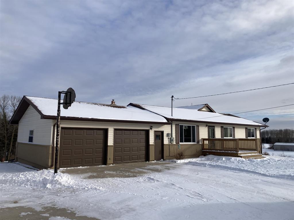 FANTASTIC COUNTRY ESTATE! Welcome to this exceptional 16.6-acre property offering space, privacy, and versatility in every direction. The main home features 1,980 sq ft on the main level plus 1,600+ sq ft in a full walkout basement, providing abundant room for a large family, guests, or multi-generational living. The inviting great room showcases vaulted ceilings and a gas fireplace, while the walkout lower level includes a second kitchen area-ideal for entertaining, extended stays, or family gatherings. Youll appreciate the thoughtful layout with main-floor laundry, a jet tub in the primary bath, hot water baseboard heat, and extensive storage throughout. Two lower-level rooms are currently used as bedrooms and could easily become legal bedrooms with the addition of egress windows, making this a potential five-bedroom home. Outside is where this property truly shines. Enjoy a finished, heated two-car attached garage, plus a 40x28 finished and heated second garage, a 28x32 pole barn with concrete floor, power, and a 12-foot lean-to, and an additional 20x20 open-face barn. Plenty of space for toys, hobbies, livestock, or equipment. Take in the views from the two-tiered back deck, explore the large apple and fruit tree orchard, garden to your hearts content, and enjoy frequent deer visits! With cement parking and wide-open space, this property offers endless possibilities-whether youre seeking a hobby farm, workshop space, or simply peaceful country living. A rare opportunity with room to grow-inside and out.