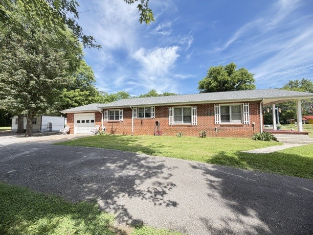 Welcome to this lovely well-maintained 3 bedroom, 2 bath brick home situated on 1.5 beautiful acres in a highly desirable location. Move-in ready and full of charm, this property would make a great starter home.  Appliances remain with the home. Also has a partial unfinished basement, great for storing your canned goods.  Step outside and enjoy the well-manicured yard with plenty of room for gardening, entertaining, or simply relaxing and taking in the peaceful surroundings. Need extra storage or workspace? The large storage building with electricity provides endless possibilities for hobbies, projects, or equipment storage. Conveniently located between Tullahoma and Winchester.
