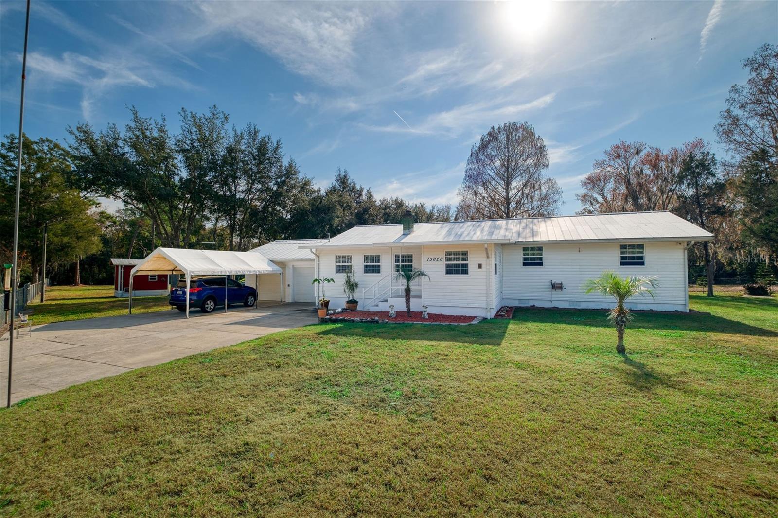 OPEN space.. calm, open, tranquil property with an active stream through the back corner .. just sit and enjoy some peace and quite  only mins from shopping and major roadways...  aprox 20 min to downtown Orlando!!! NO HOA ! This lovely three bedroom two full bath home is on a very large fenced lot, over  2 acres, surrounded on 2 sides by wooded area .Home has full kitchen with all appliances, living room with fireplace, dining room, .family/bonus room  and enclosed front porch. Attached 1 car garage with storage. Property has amazing space with 3 additional buildings  two small storage, and one  2 story barn with utilities: water, AC and power, great for workshop and/or equipment storage. This can be perfect for someone with a small business that can use this as a home base. Back deck is a great place to sit wind down and enjoy nature, birds, deer and more. Property is fully fenced yard. One car attached garage, inside utility, Plenty of parking , private road from front and back of the property. Very few properties offer so many options to its new owner. Plant a small orchard, vineyard, garden…add some solar cells maybe live off the grid but within short distance to all modern conveniences Come tour and feel the peace of having you own space!