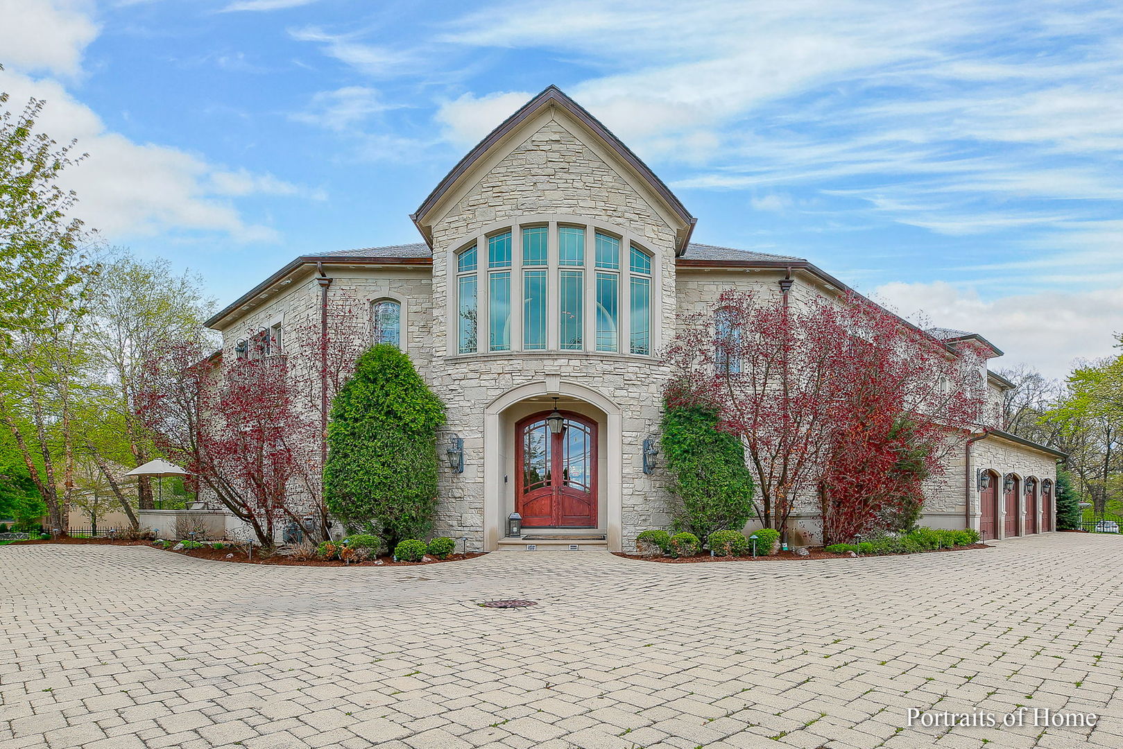 Featured as one of the Top Spotlight Homes on the Hinsdale Center of the Arts 2010 Oak Brook Home Tour: this one is unlike any you have seen. Although secluded behind the gates of an acre lot, people recognize this home with its stone exterior and abundance of windows as an architectural masterpiece on this iconic Oak Brook corner of York and Canterberry, which welcomes local cyclists to rest on the front bench adorning this home's front yard. No snow blowing here as you have a heated circular driveway!! As you step into the rich hardwoods of the interior and the opulence of ceiling heights, you recognize the long-time planning of this custom residence. The first-floor weight room and spa is any weight trainer's dream and the golf simulator room downstairs is a delight for seasoned golfers. This home has an outdoor pool and outdoor putting green as well as a guest house with a full kitchen and bedroom/bath.  The walk-out lower level with bar, rec room, wine cellar, game room, golf room, and 2-bedroom suites comprises over 4000 square feet. That is larger than the average house! There is an elevator to all floors. The 1st-floor office with a fireplace is private for the seriousness of business but cozy for friends and business acquaintances. There is also a library on the second floor open to the rest of that floor.  The second-floor master with a sitting room, fireplace, huge walk-in closets, and BRAND NEW  spa-like bath is a dream come true. With 13,760 total square footage, you will certainly have enough room to roam, and visitors will stay in the lovely coach/pool house. If you need more acreage, the adjacent property where the ranch to the south sits is also for sale for $1,500,000 !! If you are looking for something out of the ordinary that offers everything for the sophisticated active palette, then this is the one!!