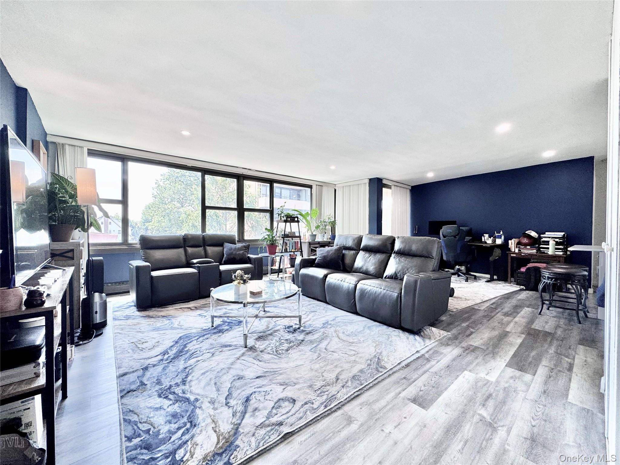 Move right in! This bright, spacious, renovated 5th-floor corner 1-bedroom at Le Havre on the Water features an open layout with flat ceilings and recessed lighting. Luxury vinyl plank flooring run throughout the space. The sleek kitchen features white cabinetry, stainless steel appliances, and a breakfast bar. Walls of windows bring in natural light throughout. The dining area and spacious primary bedroom both open to a private 20-foot terrace with a magnificent pool view. The bathroom offers a clean, modern design with a luxury shower and illuminated mirror. Generous closet space throughout provides excellent storage. As is. Convenient access to Manhattan via local and express buses, 10 minutes to the LIRR, and 25 minutes to Midtown. Washer or dryer on every other floor. Maintenance includes: taxes, heat, hot water. Amenities: fitness center/gym, 2 outdoor pools, 3 tennis courts, 2 playgrounds, clubhouse & cafe. No dogs allowed.