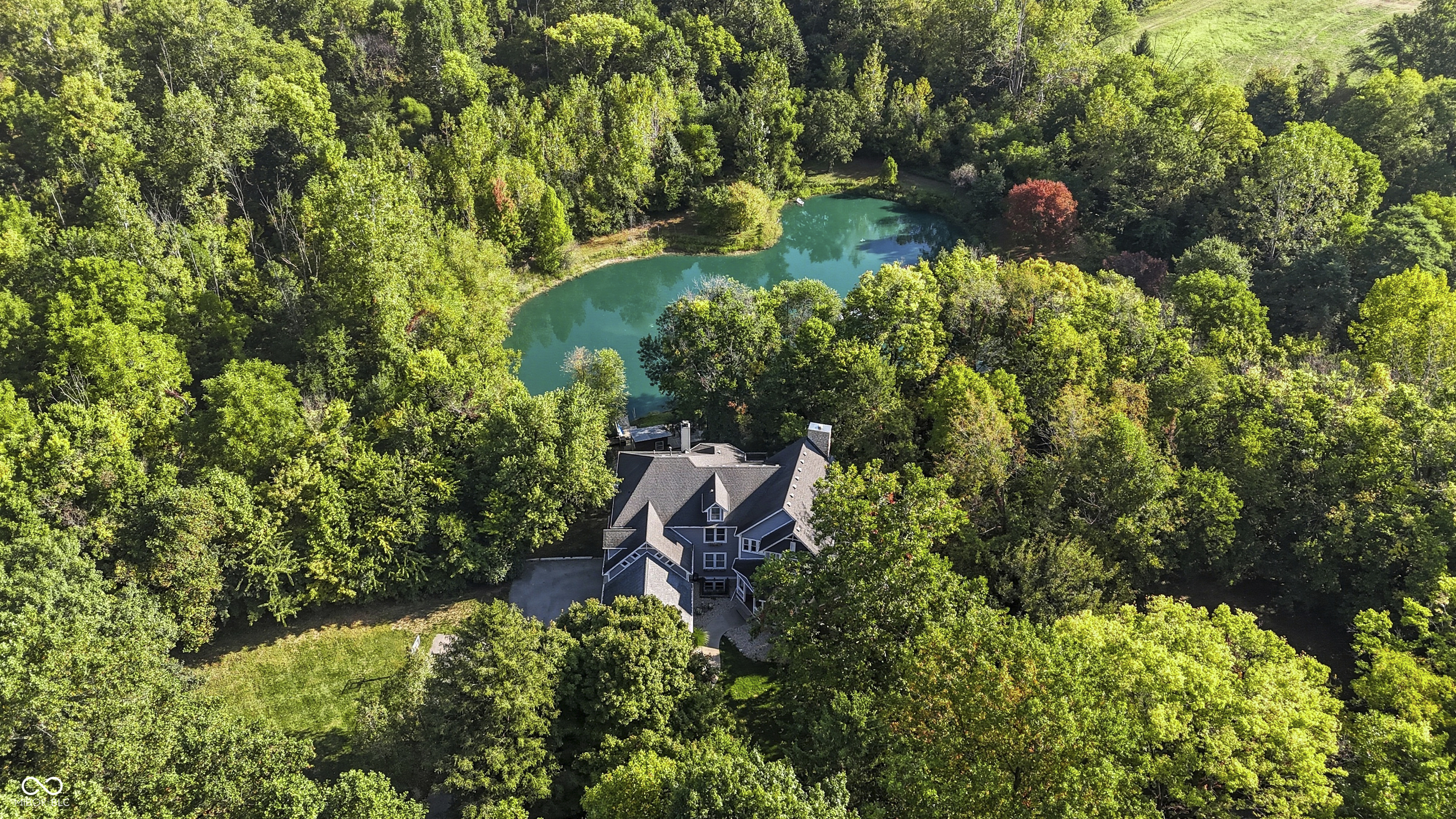 Welcome to a truly one-of-a-kind sanctuary, where modern comforts meet the serene beauty of nature. This 5-bedroom estate rests on 6.24 rare and picturesque acres, thoughtfully balanced between open fields, tranquil wooded acreage, and the presence of Mounts Run Creek. A large stocked pond, complete with a floating dock and cabana, creates the perfect backdrop for moments of relaxation and connection. Inside, a newly remodeled kitchen serves as the heart of the home, seamlessly blending sophistication and warmth. The addition of a third bay garage provides both convenience and practicality, while the expansive two-story deck offers a front-row view of the water and endless opportunities for peaceful outdoor living. The finished walk-out basement extends the home's versatility, featuring open, flexible living space along with a fully equipped apartment-style suite - ideal for guests, extended family, or a private retreat of your own. This extraordinary property invites you to slow down, breathe deeply, and embrace a lifestyle that is as exclusive as it is tranquil - a rare opportunity to own a private haven where every detail speaks to balance, beauty, and serenity.