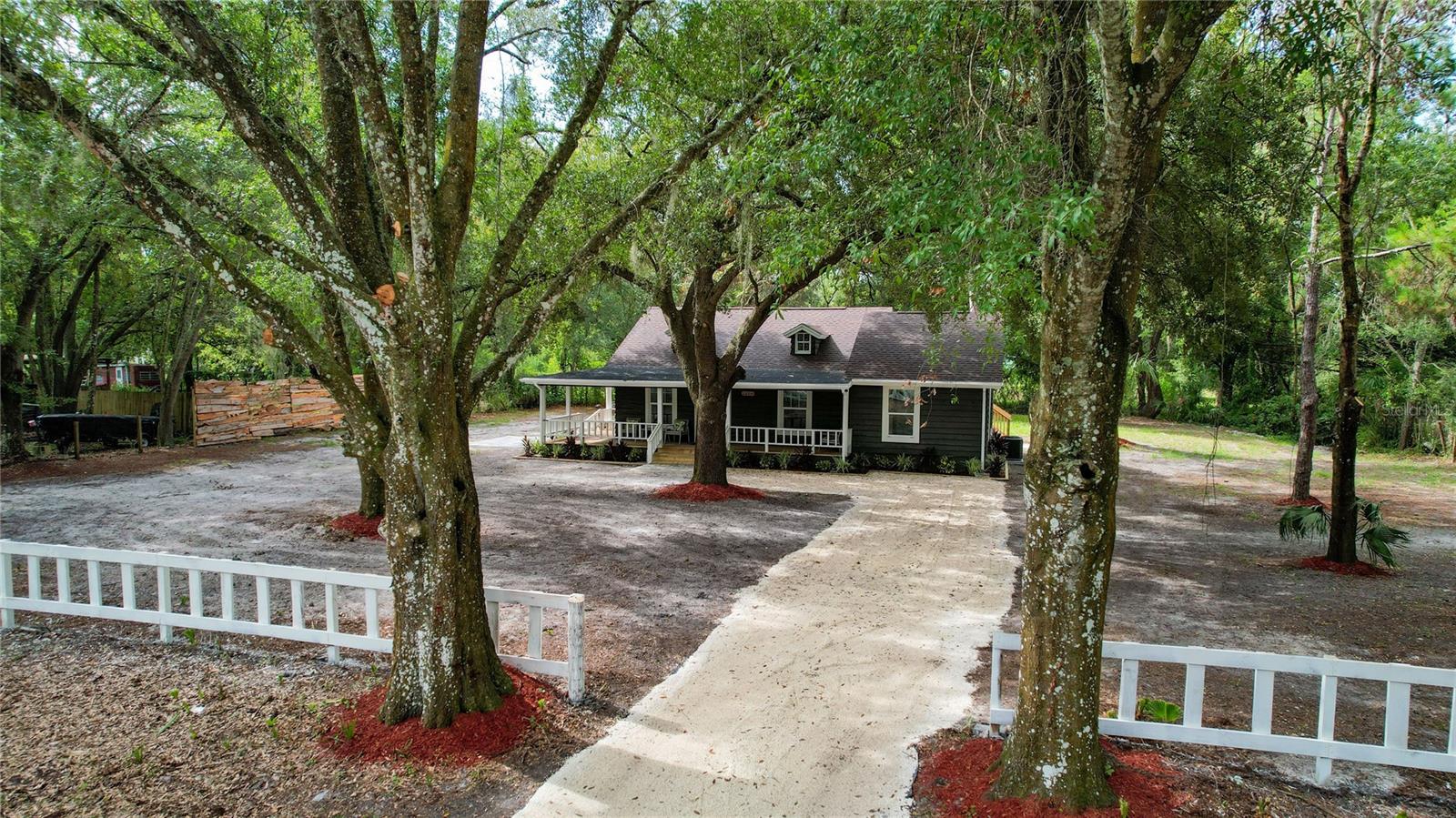 WELCOME HOME TO 26314 GLENWOOD DRIVE — BEAUTIFULLY REMODELED AND MOVE-IN READY IN WESLEY CHAPEL!This is not your typical Wesley Chapel home! Tucked away on an oversized .58-acre lot with NO HOA, this beautifully remodeled 3-bedroom, 2-bath home with Loft offers the perfect combination of modern updates, character, privacy and room to breathe.From the moment you arrive, you’ll fall in love with the charming exterior, mature shade trees and expansive covered front porch — the perfect place for morning coffee, evening conversations or simply enjoying the peaceful setting. Step inside and WOW! The home has been beautifully transformed with a bright, open-concept floor plan, gorgeous flooring, soaring ceilings and an abundance of natural light.The updated kitchen is truly the heart of the home, featuring beautiful white cabinetry, gorgeous countertops, stainless-steel appliances, stylish fixtures and a large center island with additional seating and storage. The kitchen flows effortlessly into the spacious dining and living areas, creating a wonderful layout for entertaining family and friends.  The open living area offers plenty of space to relax and includes a cozy wood-burning fireplace, adding warmth and character you simply don’t find in many remodeled homes.  With 3 bedrooms and 2 bathrooms, there is flexibility for family, guests, a home office or hobby space. The bathrooms have been beautifully updated to complement the home’s fresh, modern design. And the BIG-TICKET ITEMS have already been taken care of!  NEW ROOF • NEW A/C • NEW HOT WATER HEATER   Outside, the more-than-half-acre lot gives you something increasingly hard to find in Wesley Chapel — SPACE! Enjoy the mature trees, privacy and plenty of room for outdoor entertaining, gardening and all your Florida lifestyle plans.And best of all — NO HOA! Enjoy your property without monthly HOA fees or the cookie-cutter feel of many newer communities.Want an even easier move? The seller will consider leaving the furniture with a reasonable offer, giving buyers the opportunity for a truly move-in-ready home.   SELLER IS ALSO WILLING TO CONTRIBUTE TOWARD BUYER’S CLOSING COSTS WITH AN ACCEPTABLE OFFER!Conveniently located in Wesley Chapel with easy access to shopping, restaurants, entertainment and major roadways while still providing a peaceful setting away from the hustle and bustle.    Beautifully remodeled. 3 bedrooms. 2 bathrooms. Over half an acre. No HOA. New roof. New A/C. New hot water heater. Seller closing-cost assistance available.— schedule your private showing today!
