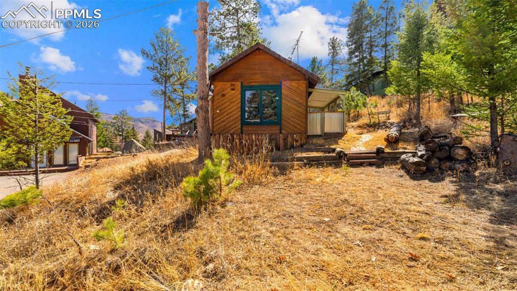 Tucked into the hillside of Green Mountain Falls, this 308 sq ft cabin is the definition of cozy mountain living. Surrounded by towering pines and set against stunning mountain views, this retreat offers the perfect escape for those craving simplicity, serenity, and a true connection to nature.Inside, the space is thoughtfully designed to maximize comfort and function, creating a warm and mountain atmosphere. Whether you’re looking for a weekend getaway, a creative retreat, or a minimalist full-time lifestyle, this cabin delivers charm in every corner.Perched on a hillside, you’ll enjoy elevated views and peaceful surroundings, with the beauty of the mountains right outside your door. With a custom door from re-models in Vail, 1 bed , 1 bath, and a perfect atmosphere of mountain living.The property is equipped with a 1,200-gallon holding tank, supporting a low-maintenance, off-the-beaten-path lifestyle. Just minutes away, the quaint mountain town offers local charm, small shops, and a peaceful lake setting—perfect for a morning coffee or evening stroll. With easy access to US-24, you’re conveniently connected to Colorado Springs for dining, shopping, and entertainment, or a quick drive up the pass to Woodland Park for additional amenities—all while enjoying the privacy and tranquility of mountain living.If you’ve been dreaming of mountain style living with character, views, and a sense of escape—this little cabin is a rare find.