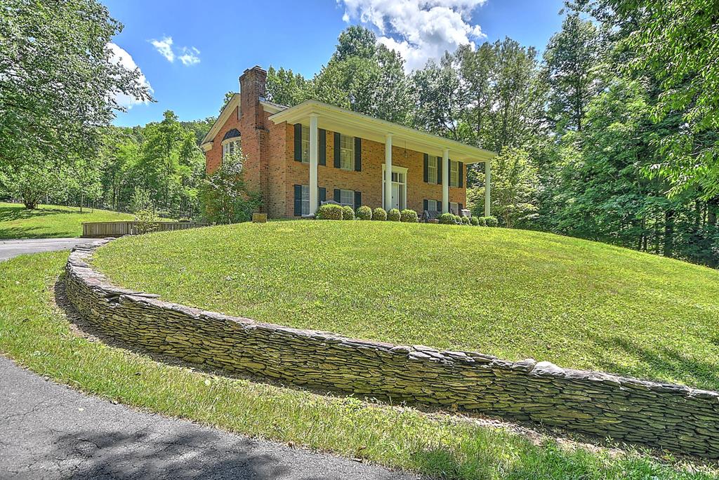 *6+ Acres of Wooded Privacy Outside Damascus* Six-plus acres of wooded privacy set the scene for this all-brick split-level home just outside Damascus. Mature trees wrap the property, blueberry bushes line the garden, and the kind of quiet that's hard to come by comes standard here. Step inside and the curved staircase in the foyer makes an immediate impression. New hardwood floors run through the whole home, and two fireplaces give the home a warmth that matches its surroundings. Solid brick construction inside and out means this one was built to last. When you're ready to explore, you're in the right place. Damascus sits at the meeting point of seven trails, including the Appalachian Trail and the Virginia Creeper Trail - a destination that draws outdoor enthusiasts from all over the country. Mount Rogers National Recreation Area and Grayson Highlands State Park are just down the road, offering everything from mountain views to miles of hiking and biking trails. People come here for a weekend and start looking for land. Privacy, character, and some of the best of Southwest Virginia right outside the door. Call your favorite Realtor today for your private showing! Buyers/Buyer's Agent to verify all information.