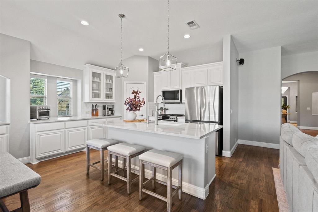 Step into this beautifully updated home, where thoughtful upgrades enhance every corner. Fresh paint, new doors, and ceilings create a bright, modern feel throughout. Designed with both comfort and functionality in mind, this home offers four spacious bedrooms on the first floor and a large game room with a full bath upstairs—perfect for family living or entertaining guests.

The island kitchen is a true centerpiece, featuring new quartzite countertops, a GE Profile gas range, and stainless steel appliances. Smart home technology adds convenience with a programmable thermostat and front door monitoring system.

Situated on a .26-acre corner lot, the property features lush landscaping and an expansive covered patio, ideal for relaxing or hosting outdoor gatherings. A custom-built storm shelter is discreetly integrated into the patio, offering peace of mind during storm season.

Additional highlights include brand-new epoxy garage floors, a custom master closet, and a three-car garage equipped with an EV charging connection. Located in the award-winning Prosper ISD, this home combines elegance, comfort, and modern innovation in a highly desirable neighborhood.