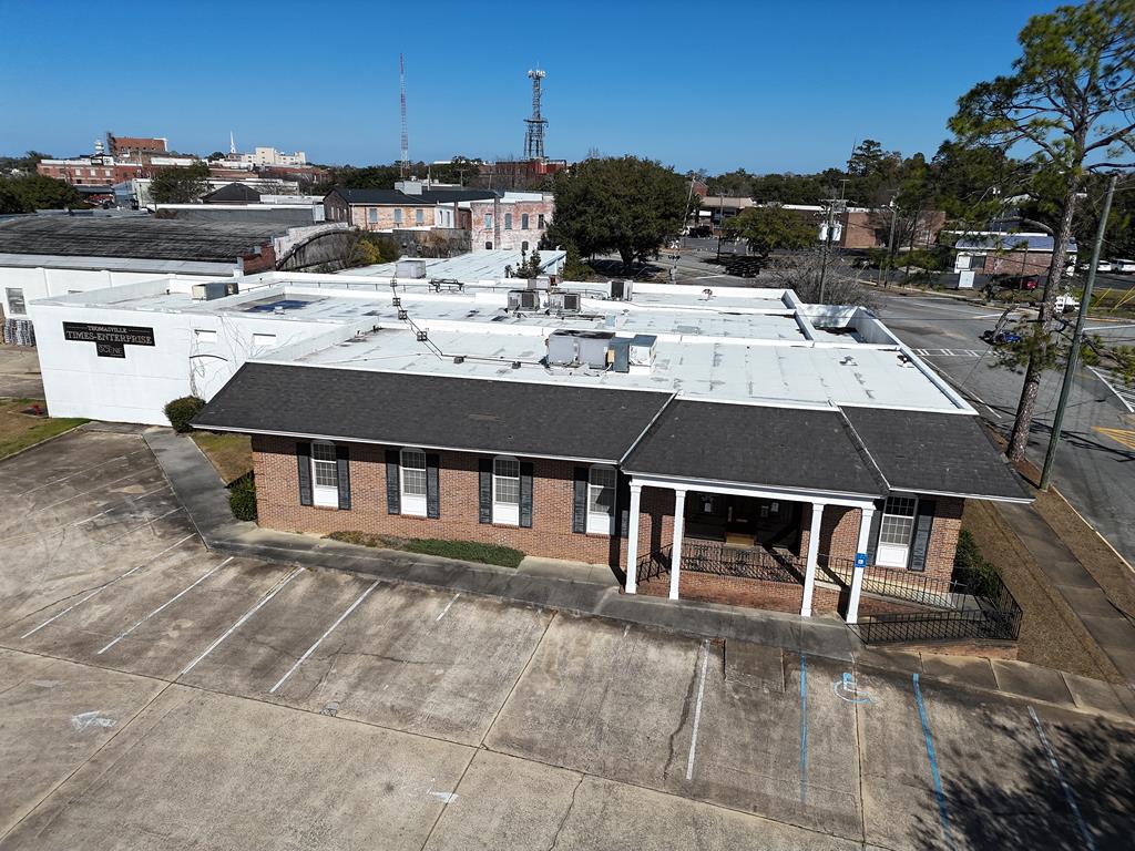Commercial building in the heart of Thomasville. Formerly home to The Times Enterprise. Office area has several private offices, public and private bathrooms, break room and plenty of storage, even a vault. The former printing plant would make a very spacious warehouse or production facility with 2 loading docks, staging areas, shipping/receiving bays and more. Buildings are concrete block and brick with 14 ft and 16 ft ceilings throughout. This is a prime property that could accommodate many uses.