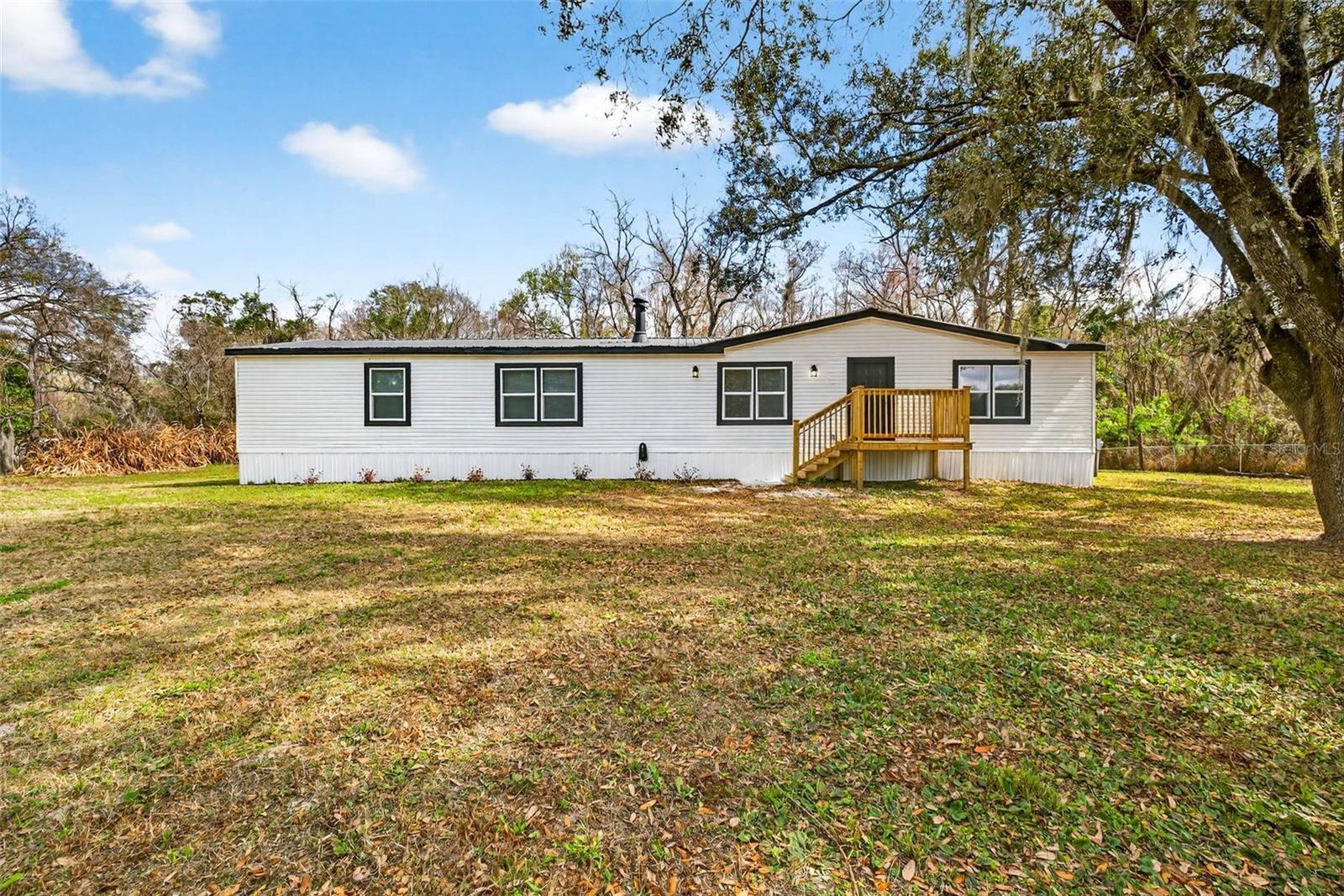 Under $300k,SPACE, PRIVACY, AND A GREAT LOCATION! Discover the perfect combination of comfort, convenience, and outdoor space with this move-in-ready 4-bedroom, 2-bath manufactured home situated on approximately 1.20 acres in the desirable Wesley Chapel area. Offering 1,872 square feet of living space, this home features a spacious open-concept layout, a desirable split-bedroom floor plan, and comfortable living areas ideal for everyday living and entertaining.NO HOA OR CDD! Enjoy the freedom and flexibility of owning over an acre of land with plenty of room for outdoor activities, additional vehicles, boats, RVs, or work trailers. Whether you're looking for extra space, privacy, or simply a place to enjoy the outdoors, this property offers endless possibilities.LOCATION, LOCATION, LOCATION! Conveniently situated near SR 54, I-75, The Grove at Wesley Chapel, KRATE, Tampa Premium Outlets, shopping, dining, and entertainment. Enjoy the convenience of nearby amenities while coming home to a peaceful setting with room to spread out.MOVE-IN READY! Opportunity to own a spacious home on over an acre in Wesley Chapel are hard to find. Don't miss your chance to make this property your own. Schedule your private showing today!