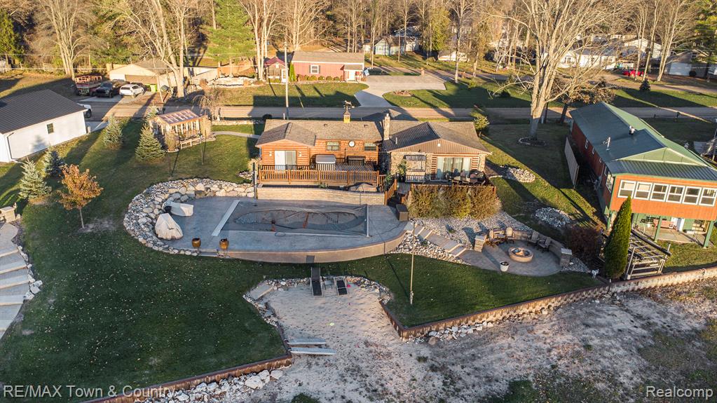 Lake living at its finest! One-of-a-kind setting with 160 feet of frontage on an amazing 2,000-acre all-sports Wixom Lake—your dream lifestyle starts right here. Spend your days soaking up the sun on the water and your evenings unwinding in your new inground, heated pool. This outdoor oasis has everything: a tiki bar, beach, cozy firepit with great patio space, amazing pool, and absolutely awe-inspiring lake views in every direction. Step inside to a warm and inviting home that’s been completely remodeled from top to bottom with new roof, windows and flooring.  Enjoy a gorgeous new island kitchen, a dining room with a pellet fireplace, beautifully updated baths, and a spacious primary suite that feels like a retreat of its own and leads you to the incredible outdoor experience. Plus all the extras you’ll love: sprinkler system, whole-house generator, invisible fence, and the cutest she-shed ever.