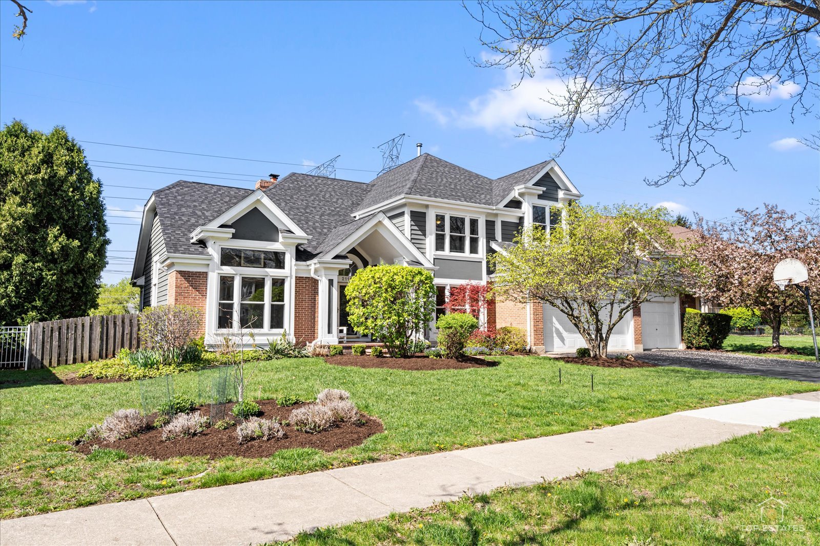 This meticulously maintained home welcomes you with a dramatic two-story foyer that flows seamlessly into an open floor plan, boasting spacious rooms with abundant natural light and Brazilian cherry hardwood floors. The heart of the home is a spacious kitchen with stainless steel appliances, including two full-sized refrigerators, and granite countertops, complemented by a bright eating area. The main level features a dedicated office and a cozy den/additional office. Upstairs, you'll find four bedrooms and two full baths, including a spacious primary suite with a bathroom featuring double sinks and a separate tub and shower. The living space extends into a fully finished basement, perfect for entertainment, complete with a combination pool, air hockey, and ping pong table. Huge fenced yard with brick paver patio. New roof in 2025. Air conditioner and A coil in 2020. Front windows and back slider in 2017. Situated in a charming neighborhood, this property offers access to award-winning schools, including Prairie, Twin Groves, and Adlai E. Stevenson High School. Close to parks and shopping!