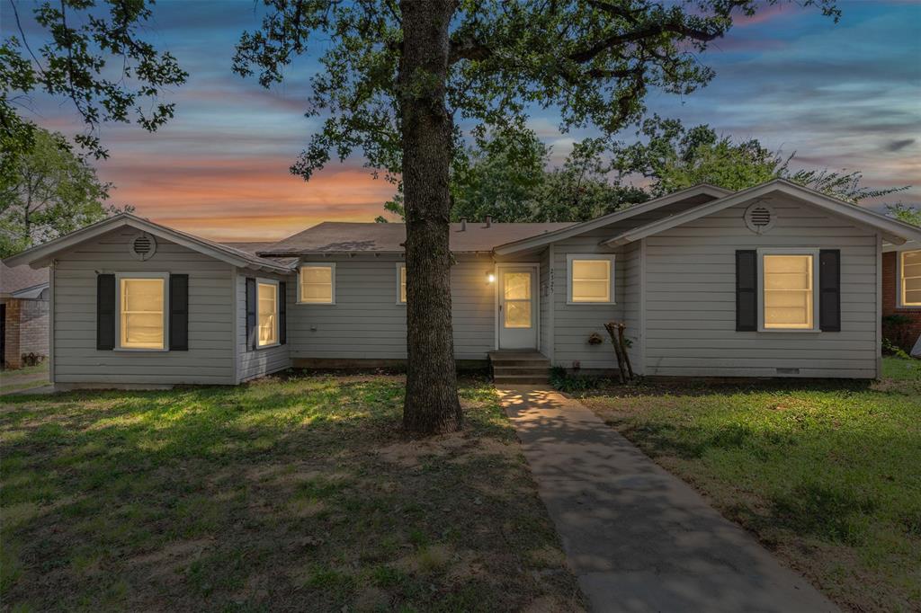 Nestled on a generous 0.2324-acre lot with an additional 0.4494-acre parcel just behind it at 2317 Halbert Street, this East Fort Worth property offers a rare combination of charm, space, and potential. The 3-bedroom, 1-bath home welcomes you with original hardwood floors, graceful arched doorways, and a timeless layout that radiates vintage character. A front bedroom wrapped in original pine paneling creates a cozy retreat—or easily transforms into a second living space if three bedrooms aren’t needed.

Recent updates bring peace of mind, including new gas lines (October 2024) and new sewer lines to the street. Outside, mature oaks and a striking 54-year-old pine tree from Wyoming provide shade and natural beauty around the circle driveway. A detached garage with carport offers both parking and storage, while the expansive backyard is ready to become anything you envision—whether that’s a lush garden, outdoor entertaining oasis, or workshop.

The additional rear parcel opens up even more opportunities. Keep it as extra space, explore new construction, or pursue rezoning for multi-family use (with city approval). For homeowners, it’s room to grow. For investors and developers, it’s a pathway to added income and long-term value.

Homes with this much land, character, and flexibility rarely come available in East Fort Worth. Don’t miss your chance to create, invest, or simply enjoy a property with unlimited possibilities.