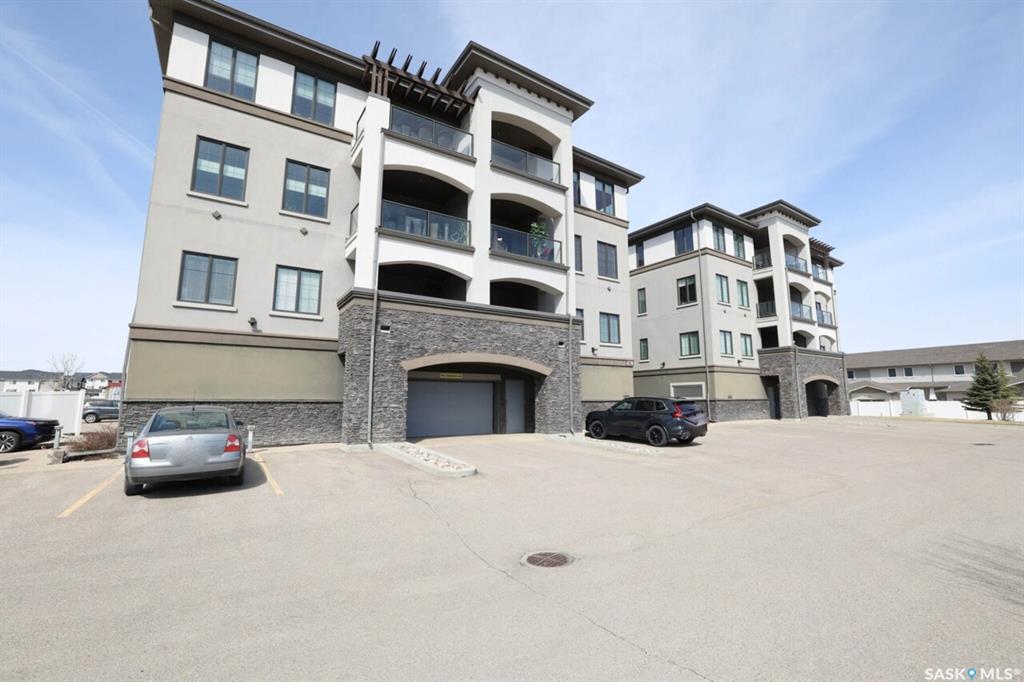 Welcome to this highly desirable condo at Harbour Pointe, expertly crafted by Gilroy Homes. This beautifully designed 1,425 sq. ft. unit offers 2 spacious bedrooms, 2 modern bathrooms, and a versatile den within the primary suite, combining comfort, style, and functionality in one exceptional package.From the moment you enter the inviting foyer, you’ll appreciate the abundance of natural light flowing through the expansive windows in the open-concept living and kitchen area. The living room features impressive 9-foot ceilings, enhancing the bright and airy feel throughout the space.The kitchen is both elegant and practical, showcasing stainless steel appliances, dark stained maple cabinetry, pot drawers, a tiled backsplash, sleek quartz countertops, a convenient corner pantry, and eating bar — perfect for casual dining and entertaining alike.The dining area opens seamlessly onto the large covered balcony, creating the ideal outdoor space for relaxing or entertaining while enjoying added privacy and protection from the elements.The spacious primary suite is a true retreat, featuring a walk-in closet, well-appointed 3-piece ensuite, and an adjoining den that makes the perfect home office, reading nook, or sitting area. A second generously sized bedroom, 4-piece bathroom, and laundry/storage room with additional cabinetry complete this thoughtfully designed layout.Condo fees include heat and water for added value and convenience. This unit also includes one underground parking stall and a private storage cage located in the parkade.This wheelchair-accessible building offers excellent amenities including an elevator, fitness room, guest suite, and a large amenities room, all within a welcoming community atmosphere. Ideally located near all Harbour Landing amenities, shopping, walking and biking paths, and just a short 5-minute drive to the airport, this is condo living at its finest in Regina.Contact your REALTOR® today to schedule your private showing.