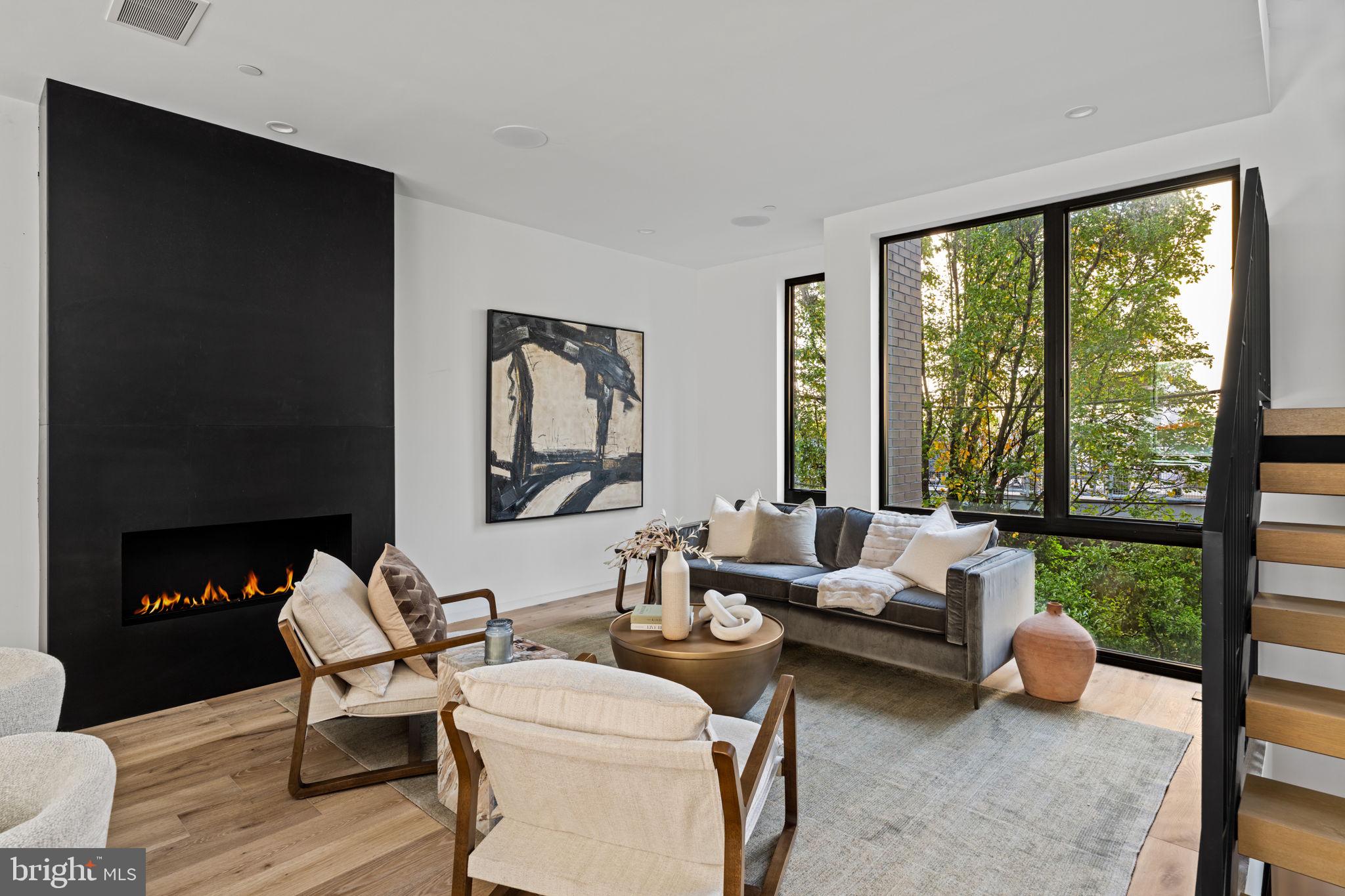 You’re Almost Home: The Kenilworth III new construction homes offer ultimate townhome living.     MOVE IN READY! Spread across 3100 SF of living space plus an additional 800 SF finished basement, you’ll find top-level finishes, carefully thought-out open floor plans, a five-stop elevator, 9’+ floor-to-ceiling windows, custom metalwork, recessed millwork, and Savant smart home integration. Enter the home through a custom 4’ wide pivot hinge entry door, and you will first find a convenient home office with an en-suite powder room and a built-in coat closet in the main hallway.        Upstairs, the living space is anchored by a gas fireplace with a custom blackened steel surround and wide-plank hardwood flooring.  Next, you will find a well-curated kitchen finished with Miele appliances, 48” panel-ready fridge, a built-in coffee maker, sleek wood-grain cabinetry, a tiled floor with large format tiles, sophisticated black honed counters, and an additional wet bar area with an additional built-in fridge.        On the 3rd floor you will find 2 bedrooms with custom closets, an additional living/lounge area, a walk-in laundry room, and a spa-inspired hall bathroom with porcelanosa tile, Watermark fixtures, and a heated tile floor.     The 4th Floor primary suite encompasses the top level featuring 10’+ ceilings, unobstructed city skyline views from the 10’ tall windows with green roofs right outside, a primary spa equipped with a built-in steam shower system, matte black soaker tub, and a large dual sink vanity and a private water closet.  In addition, the primary has an impressive walk-in closet with over 26’ of built-in cabinetry.  Lastly, finishing off the fourth floor includes another wet bar area and a separate powder room set up perfectly for roof deck entertainment.     The basement is another great place to entertain guests with a superb layout for a home theatre and includes a 3rd conveniently located wet bar, a fourth bedroom, and another spa-inspired bathroom. Additional features of this home include a two-car garage with electric car charging, a 4-zone HVAC system, and a designer steel staircase from top to bottom with custom-fit 4” oak treads.       This home is built of the highest quality materials for ultimate luxury living. Take advantage of stunning rooftop views, quiet cul-de-sac streets, and a full  10-year tax abatement. Graduate Hospital is an extremely walkable neighborhood home to an abundance of restaurants, shops, and is just steps from Center City.Ready for move in!!