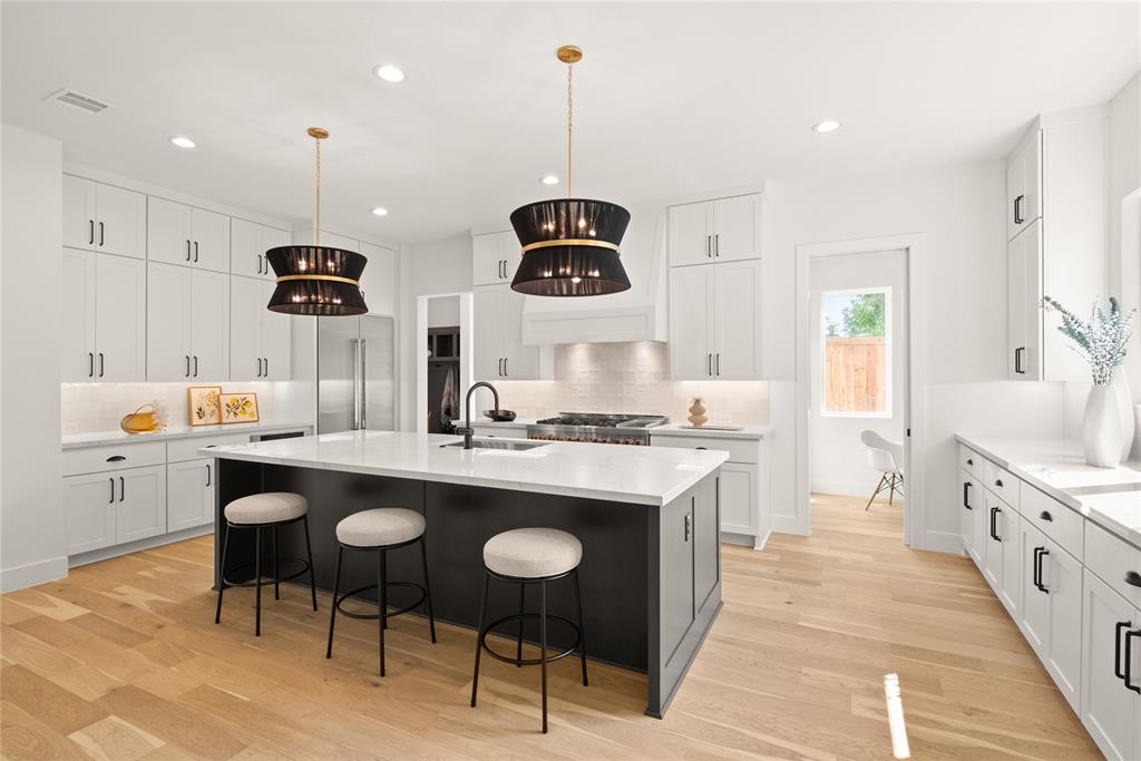 MLS# 20974814 - Built by Homebound - Ready Now! ~ Step into refined comfort in this stunning new construction home, nestled in the heart of the beloved Little Forest Hills neighborhood. Designed with livability in mind, this home combines modern luxury with thoughtful details to enhance everyday life. From the moment you enter, natural light pours through oversized windows, creating a warm and welcoming atmosphere. Just off the entry, a flexible room with a full bath is ready to serve as a serene home office, cozy guest retreat, or even a playroom—tailored to your lifestyle. The open-concept main level invites connection and flow, with a spacious great room and dining area perfect for hosting friends or enjoying quiet nights in. A chef-worthy kitchen anchors the space, complete with JennAir appliances, sleek Dekton countertops, soft-close cabinetry, and an oversized island ready for meal prep, morning coffee, or homework sessions. A hidden walk-in pantry keeps everything organized and out of sight. Tucked behind the kitchen, a smartly placed pocket office is ideal for remote work or creative projects, while a generous mudroom keeps daily life running smoothly. Indoor-outdoor living is seamless here—double sliding doors open to a covered patio overlooking the expansive backyard, ideal for weekend barbecues, sunset dinners, or stargazing under Texas skies. Upstairs, the serene primary suite offers a peaceful escape, complemented by two additional bedrooms—each with its own bath—perfect for family, guests, or personalized use. Enjoy peace of mind with a 1-2-6 builder warranty and a 3-year complimentary home automation package. Plus, with late-stage personalization still available, buyers have a unique opportunity to choose select interior finishes and make this home truly their own.