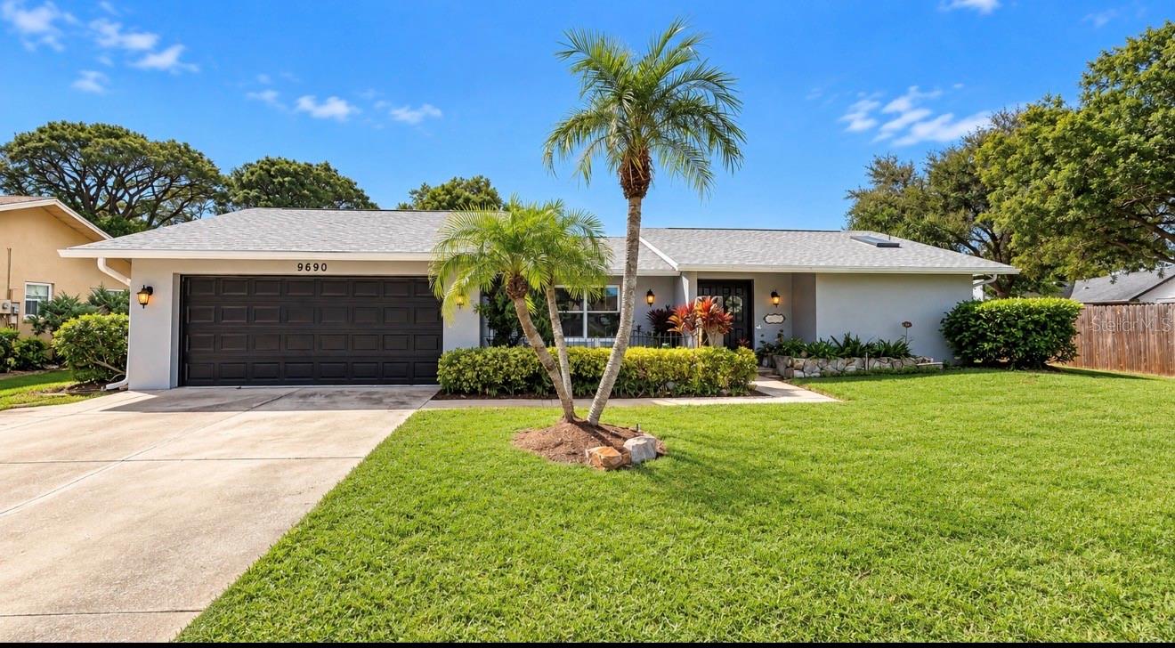 FLORIDA LIVING WITH ROOM TO RELAX, ENTERTAIN AND ENJOY! Welcome to 9690 Leeward Avenue in Lakeside Estates, where an inviting 3-bedroom, 2-bath home with a 2-car garage combines thoughtful updates, a private pool and spillover spa, and an exceptionally spacious yard. Built in 1982, this home offers a desirable split floor plan and the indoor-outdoor lifestyle that makes Florida living so special. One of the home's standout features is the double-pane pocket sliding glass doors installed in March 2021. All sliders leading to the pool lanai tuck away, opening the living spaces to the outdoors and creating a wonderful setting for gatherings, weekend relaxation or an evening by the pool. Enjoy a refreshing swim, unwind in the spa, or simply settle into your favorite chair on the enclosed lanai. Set on one of the largest lots in Lakeside Estates, this property offers the rare combination of a pool and a generous yard with plenty of room for outdoor games, gardening and memorable gatherings. Inside, tile flooring installed in the main living areas in 2021 brings a cohesive look and easy everyday maintenance. The family room features a wood-burning fireplace, adding warmth and character for those cooler evenings. The split bedroom layout provides welcome separation, while the primary suite offers a large walk-in closet, direct access to the pool lanai and the primary bathroom was remodeled in October 2023. An inside laundry room adds everyday convenience. A substantial list of improvements enhances this home's appeal: NEW ROOF in May 2025, A/C replaced in 2022, NEW double-pane windows and hurricane fabric storm panels in August 2020, and a NEW hurricane rated garage door in February 2023. The home was also repainted in 2025, complementing the care and investment made throughout the years. From quiet mornings beside the pool to evenings gathered around the fireplace, this home offers comfortable spaces to enjoy every season. With major updates already completed, an inviting layout and an oversized lot that leaves room to spread out, this Lakeside Estates property is ready for its next chapter. Schedule your private showing and discover the possibilities of making it your own! Home details, measurements, improvements, ages of components, furnishings, and information are believed accurate but are not guaranteed. Buyers should independently verify all information and conduct any inspections deemed necessary.