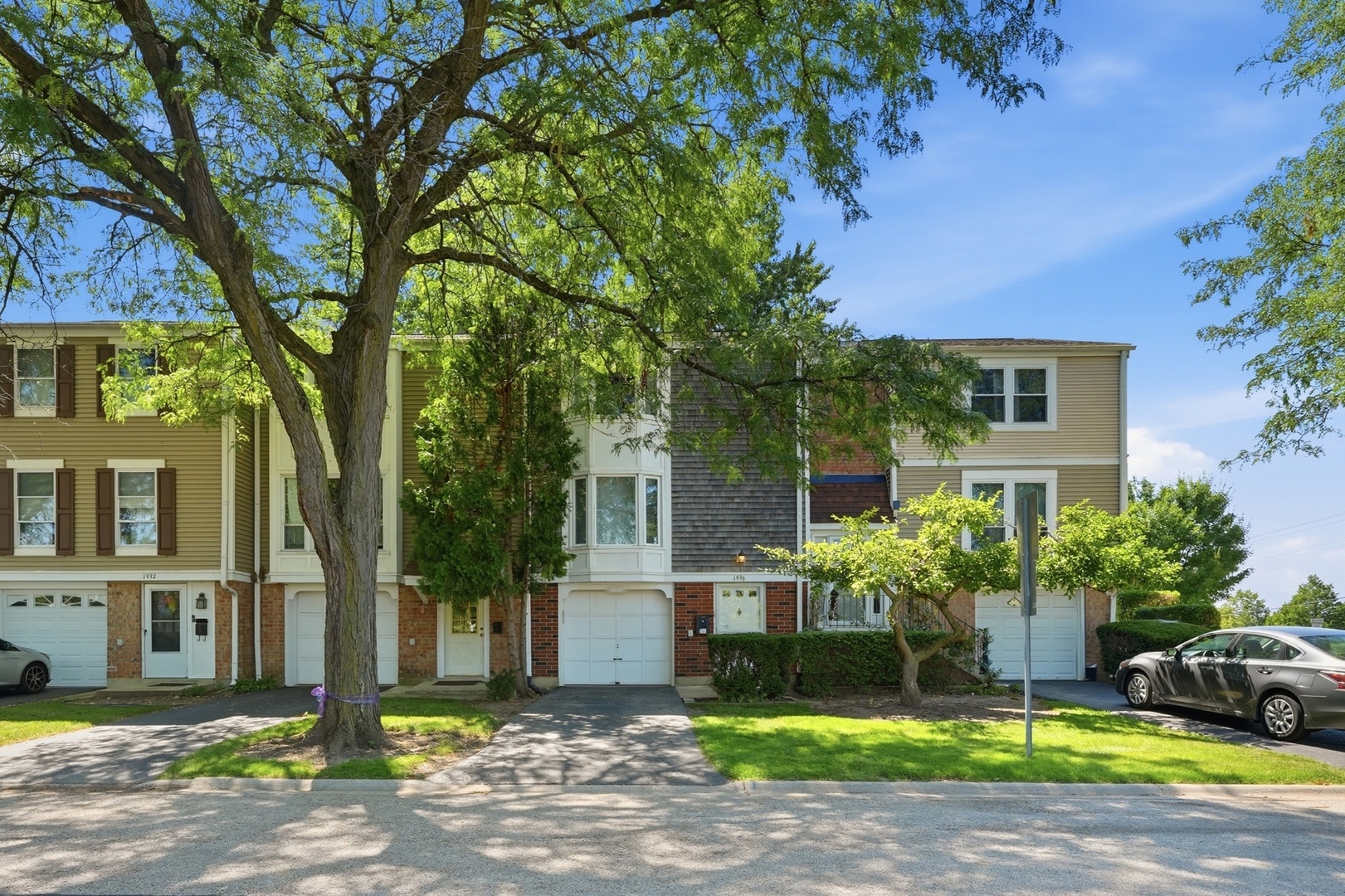 Move-in ready and beautifully updated townhome featuring an open floor plan, designer kitchen with quartz countertops, stainless steel appliances, white cabinetry, exposed brick accents, updated bathrooms, finished lower level, and a private patio overlooking open green space. This home offering extra privacy and a beautiful view. Reverse osmosis water filtration system (2023) adds even more value. Furnace (2020), AC (2020), Water Heater (2020), Humidifier Aprilaire 800 (2023), Water Softener (2023), Smart Thermostat (2023) Windows and Patio Door (2021), Kitchen (2021), Bathrooms (2021), Updated electrical panel and fixtures, Murphy bed (2023), Dishwasher (2026), Gas range (2026), EV Charging outlet. Located in the desirable Barrington Square community, this property is also investor-friendly, making it an excellent opportunity for both homeowners and investors alike. Conveniently located near parks, shopping, dining, and major expressways.
