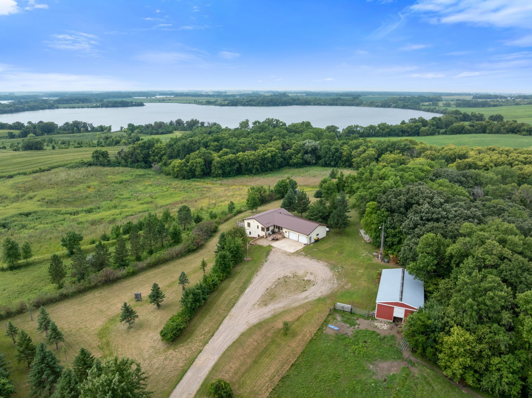 A setting like this is what country living is all about! This desirable rambler is surrounded by rolling, picturesque land and showcases a “million-dollar view” overlooking Swan Lake. Hunters Paradase with multiple types of game and 7 Deer Stands already in place! Step onto the sprawling deck and take in the sweeping views, beautiful elevation, and peaceful countryside—a setting that is impressive in every season. The home offers convenient main-level living, a newer metal roof, and a private primary suite featuring an updated walk-in shower. Outside, the large outbuilding adds tremendous versatility with box stalls and plenty of room for animals, equipment, recreational toys, a workshop, or additional storage. Whether you're dreaming of a hobby farm, space for horses, or simply room to spread out and enjoy the outdoors, this property delivers. Exceptional land, incredible views of Swan Lake, and the privacy and space that make country properties like this so special.