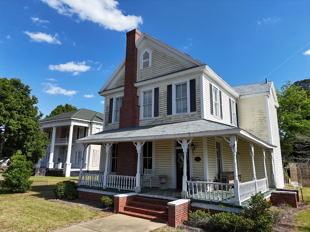 Take a step back through time in this WONDERFUL 20th CENTURY property in the heart of Camilla, GA! This gorgeous 2-story has been lovingly cared for, first as a home, and now as one of Camilla's most beloved businesses. The front entrance opens to a foyer with a grand staircase, formal living room, and dining room. There is a nice kitchen, breakfast area, den, laundry/utility room, and work room all on the first floor. The second floor has three bedrooms – which could also be converted to 2 bedrooms and a den -- and a special attic with ceiling windows, PERFECT for all your storage needs. You can sip coffee on the covered back patio or catch up with the neighbors from the wrap-around front porch. Building is currently zoned commercial and is uniquely positioned along Camilla's busiest street – sure to attract local shoppers. NOTE: This sale is for property only – the current business is not for sale. Call your favorite agent TODAY for a closer look at this wonderful property. Click here for virtual tour: https://my.matterport.com/show/?m=pTVTq5vmCt9&mls=1