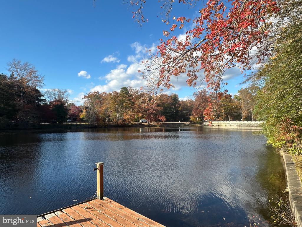 Step back in time and experience the charm of this beautifully preserved 1920’s LAKEFRONT log cabin, offering 185 feet of prime water frontage and breathtaking views. A rare blend of rustic character and modern comfort, this 3–4 bedroom, 2-bath home spans approximately 1,960 square feet and captures the essence of classic lakeside living.The inviting great room features soaring vaulted ceilings, rich hardwood floors, and a stunning stone fireplace—perfect for cozy evenings year-round. A spacious screened-in porch provides the ideal setting for relaxing with morning coffee or enjoying sunset views over the water. The long balcony enhances the home’s connection to its picturesque surroundings.  .An upper-level primary suite addition offers privacy and comfort, while the flexible floor plan allows for three to four bedrooms to suit your needs. The full walk-out basement provides additional space and easy access to the outdoors.Outside, enjoy 185 feet of water frontage complete with a bulkheaded dock—ideal for boating, swimming, and lakeside entertaining. The home has a two-car garage with a circular driveway offering convenient access and ample parking.Modern updates include central air conditioning, gas heat, public water and sewer, vinyl replacement windows, and a newer heating system with new duct work—ensuring comfort and efficiency without sacrificing the cabin’s original character.This special lakefront retreat is a rare opportunity to own a piece of history with many of the comforts of today. AS IS SALE