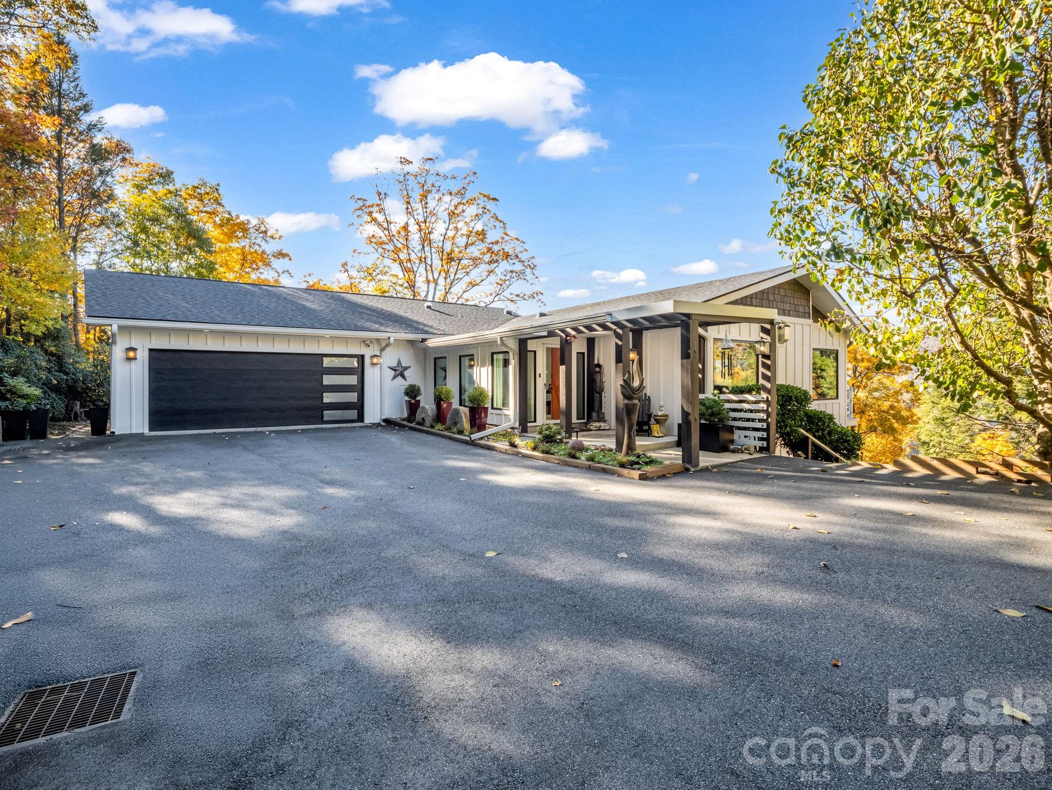 An elevated mountain retreat offering a rare balance of design sophistication and natural beauty. Fully renovated and oriented to capture sweeping, year-round panoramic Blue Ridge Mountain views, this contemporary-modern ranch presents an open, light-filled floor plan where expansive glass, vaulted ceilings and modern lighting create a seamless dialogue between interior spaces and the landscape beyond. High-end finishes and curated details lend a sense of quiet luxury throughout. The elevated decks and terraced outdoor living spaces provide a private setting for entertaining, reflection and sunset views. Ideally minutes from Tryon and centrally positioned between Charlotte, Asheville and Greenville, this turnkey residence delivers refined comfort, enduring craftsmanship and a serene, nature-centered lifestyle. Extensive structural and mechanical updates throughout. See Disclosures and Feature Sheet for additional details. By appointment only, no drive-bys please. Owner occupied.