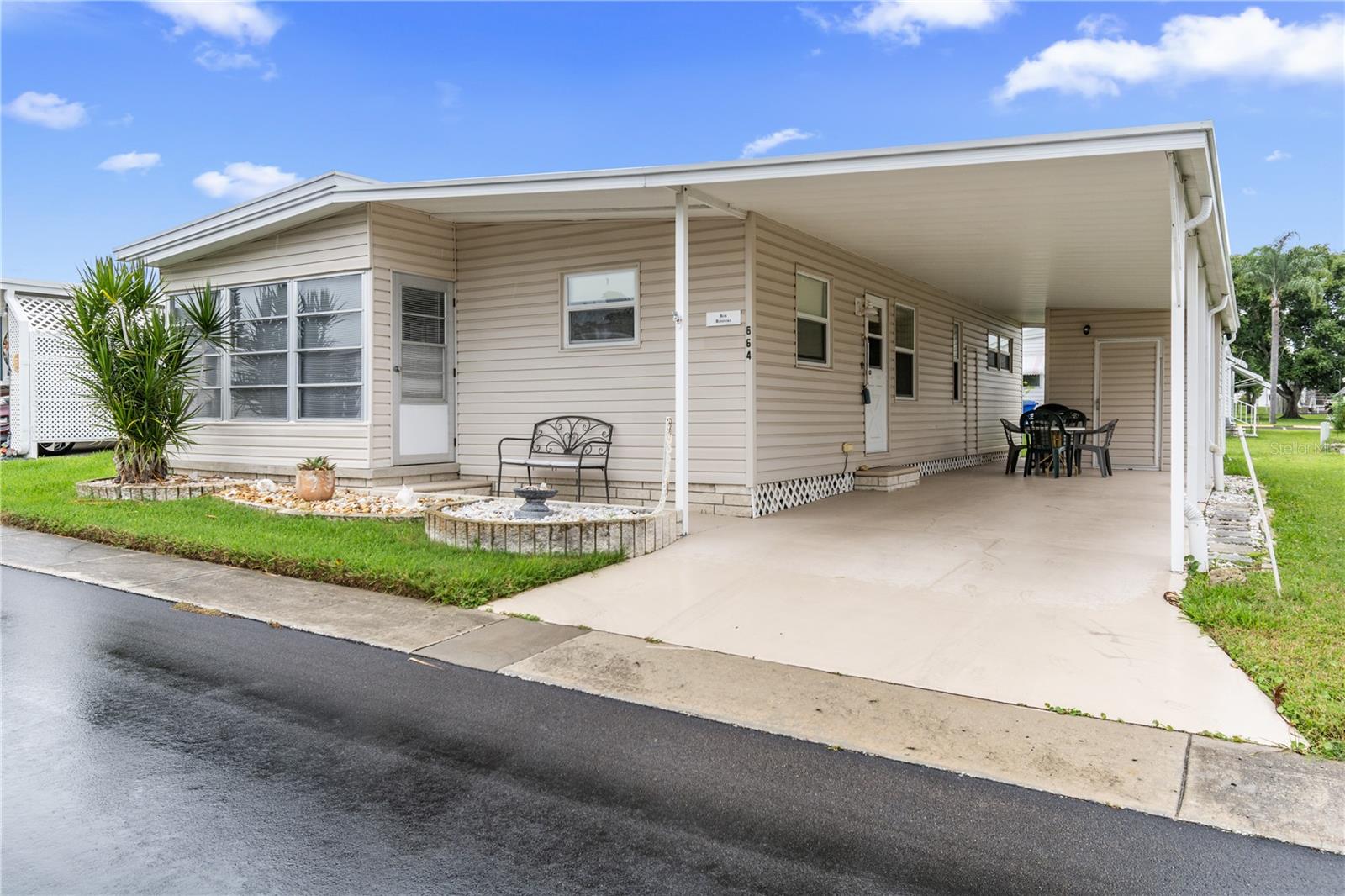 Welcome to your ideal Florida retirement retreat in the highly desirable Palm Hill Mobile Park, an active 55+ community in Largo, FL. This beautifully maintained and fully furnished, turnkey double wide manufactured home, offering both comfort and convenience. Featuring 2 bedrooms and 2 bathrooms, the spacious layout provides ample room for guests, while the large enclosed Florida room invites you to relax and enjoy the sunshine all year long. Recent upgrades include all new laminate flooring throughout and a replaced electrical breaker box in 2023, ensuring peace of mind and modern efficiency. Additional highlights include an indoor laundry room, plenty of storage space, and a covered carport for protected parking and extra outdoor living.
Palm Hill is one of Pinellas County’s most sought-after 55+ communities, offering exceptional amenities designed for active adults. Enjoy three swimming pools, two clubhouses, shuffleboard courts, a pool room, tennis and pickleball courts, and a golf course with optional membership. This golf cart-friendly neighborhood also features a spa, bicycle club, and a welcoming calendar of social events. It’s also pet-friendly, allowing one small pet up to 20 lbs.
The monthly HOA fee includes lawn care, water, sewer, trash, cable, internet, and all amenities, providing simple, stress-free living. Perfectly located just minutes from top-rated Gulf beaches, excellent dining, shopping, and the vibrant cultural hubs of St. Petersburg, Clearwater, and Dunedin, this home is ideal for those seeking an active yet relaxed coastal lifestyle.
Please note: This is a cash-only purchase, as traditional financing is not available for co-op ownership. The share price is included in the asking price. Don’t miss your opportunity to own this updated, move-in-ready home in one of Pinellas County’s most vibrant 55+ communities. Schedule your private tour today!