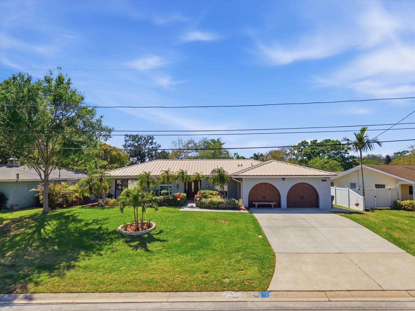 Welcome to this meticulously maintained and extensively updated 3-bedroom, 2.5-bath residence with a versatile flex room that can easily function as a fourth bedroom, home office, or additional living space. Offering approximately 2,268 square feet, this move-in-ready home blends thoughtful upgrades with functional design and modern comfort.Major system improvements provide true peace of mind, including a 2024 Rheem HVAC system, 2023 electric water heater, upgraded 200-amp electrical panel (2023), updated ductwork (2016), and a durable metal roof (2010) complemented by oversized gutters and French drains. Significant plumbing updates were completed during the full bathroom renovations.All bathrooms have been fully remodeled with high-end finishes. The primary suite features a spa-inspired bathroom rebuilt from the studs, showcasing a jetted soaking tub, triple-head shower system, dual vanities, custom tilework, and enhanced lighting and ventilation. The secondary bathroom (2022) offers a curbless walk-in shower with hidden drain, pebble tile accents, premium waterproofing, and a Miami-Dade rated exterior door. The half bath has also been beautifully updated.The kitchen has been refreshed with updated appliances, including a range (2020), dishwasher (2024), and refrigerator (2025). Flooring throughout includes a blend of wood, bamboo, tile, vinyl, and newer carpeting, adding warmth and durability throughout the home.Most windows and doors have been upgraded to wind-resistant models, including oversized arched windows with plantation shutters (2025), pocket sliding glass doors (2022), and a Miami-Dade rated exterior door. Hurricane-rated garage doors further enhance protection.Step outside to a completely transformed outdoor living space designed for year-round enjoyment. The pool and deck were fully remodeled in 2023 and feature a resurfaced pool, elegant travertine decking, and dual waterfalls with integrated fire features. The advanced Hayward smart pool system includes a heater and chiller for year-round swimming, a variable speed pump, and convenient app-based controls. A private outdoor shower with hot and cold water adds to the resort-style experience. The screened lanai (rescreened in 2025) is equipped with weatherproof fans and multiple sliding glass access points, creating seamless indoor-outdoor living.Additional exterior upgrades include full exterior paint (2025), updated landscaping with palms and mature plantings, and underpinning completed in 2019 for added structural stability.This exceptional property offers a rare combination of major system upgrades, high-end renovations, and true Florida outdoor living—delivering both luxury and peace of mind in a completely move-in-ready home.