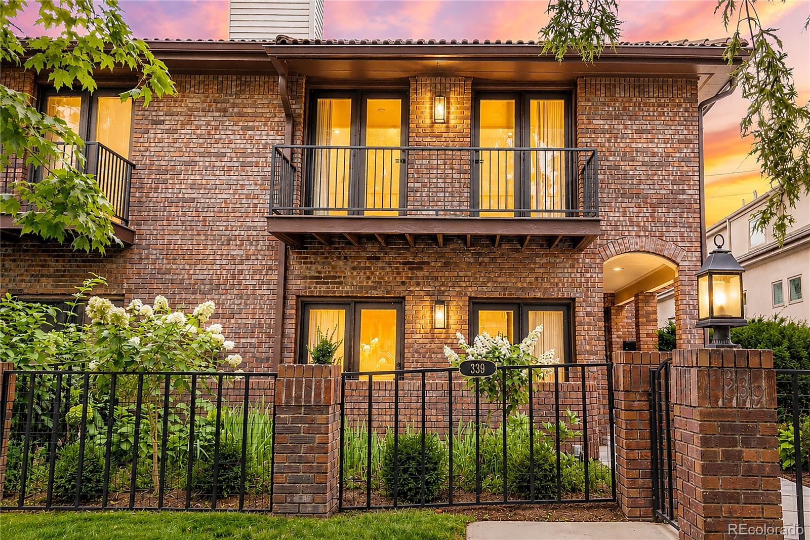 Tucked into one of Cherry Creek North's most sought-after blocks, this beautifully remodeled townhome invites you to slow down and settle in. Step inside and you're greeted by custom-cut white oak herringbone floors flowing throughout the main level — the kind of detail that makes every day feel a little more special. The heart of the home is a chef's kitchen made for gathering, with custom white oak cabinetry, waterfall Cristallo Quartzite countertops, and a suite of top-tier appliances, including a 48-inch Thermador range. Just beyond, the homeowners have installed two new custom gas fireplaces, framed in fluted white oak, anchoring both living spaces with warmth and style. A three-panel bi-fold door opens the main floor to seamless indoor-outdoor living — ideal for summer evenings or quiet mornings with coffee. Upstairs, the primary suite feels like a private retreat: a spa-inspired bath with a soaking tub, heated floors, and a spacious custom closet designed to keep life organized and calm. The secondary additional bedroom opens onto two balconies, offering a personal outdoor escape. Downstairs, a fully finished basement adds even more room to live and entertain, two laundry areas, and generous storage space. Thoughtful mechanical upgrades — including a tankless water heater and whole-house humidifier — bring comfort and ease to everyday living. And for those who love their vehicles, the garage's newly epoxied floor soaring 15-foot ceiling leaves room to imagine, with space for a lift and up to four cars. This is the only unit with an attached garage in the complex. This is more than a home — it's a place to gather, unwind, and truly live well.