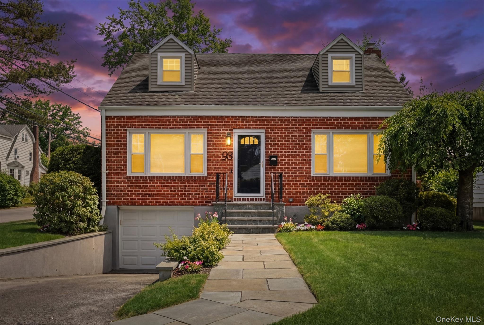 Picture-perfect Cape Cod situated on a desirable corner lot in the heart of the Highlands neighborhood of White Plains. Completely renovated, this brick home features all-new windows and new vinyl siding, offering timeless curb appeal paired with modern efficiency. A spacious entry foyer welcomes you into sun-filled interiors highlighted by gleaming hardwood floors throughout. The inviting living room is enhanced by a large picture window, while the elegant dining area opens to a wood deck and stone patio, ideal for indoor-outdoor entertaining. The private backyard is fully fenced with stockade fencing and enhanced by newly added landscaping shrubs, creating an enchanting and tranquil setting. The charming kitchen showcases white cabinetry, granite countertops, stainless steel appliances, and classic country appeal. Three generously sized bedrooms are complemented by a versatile den/home office, allowing the home to live like a four-bedroom. An impeccably updated hall bath completes the main level. The lower-level basement offers a versatile, multi-functional recreation space, laundry area, and convenient access to the garage. Fixed plumbing is already in place, presenting an excellent opportunity to add a bathroom and further enhance the space. Ideally located close to Metro-North, shopping, fine dining, parks, schools, and major highways, this exceptional home delivers privacy, flexibility, and convenience in one of White Plains’ most desirable neighborhoods.