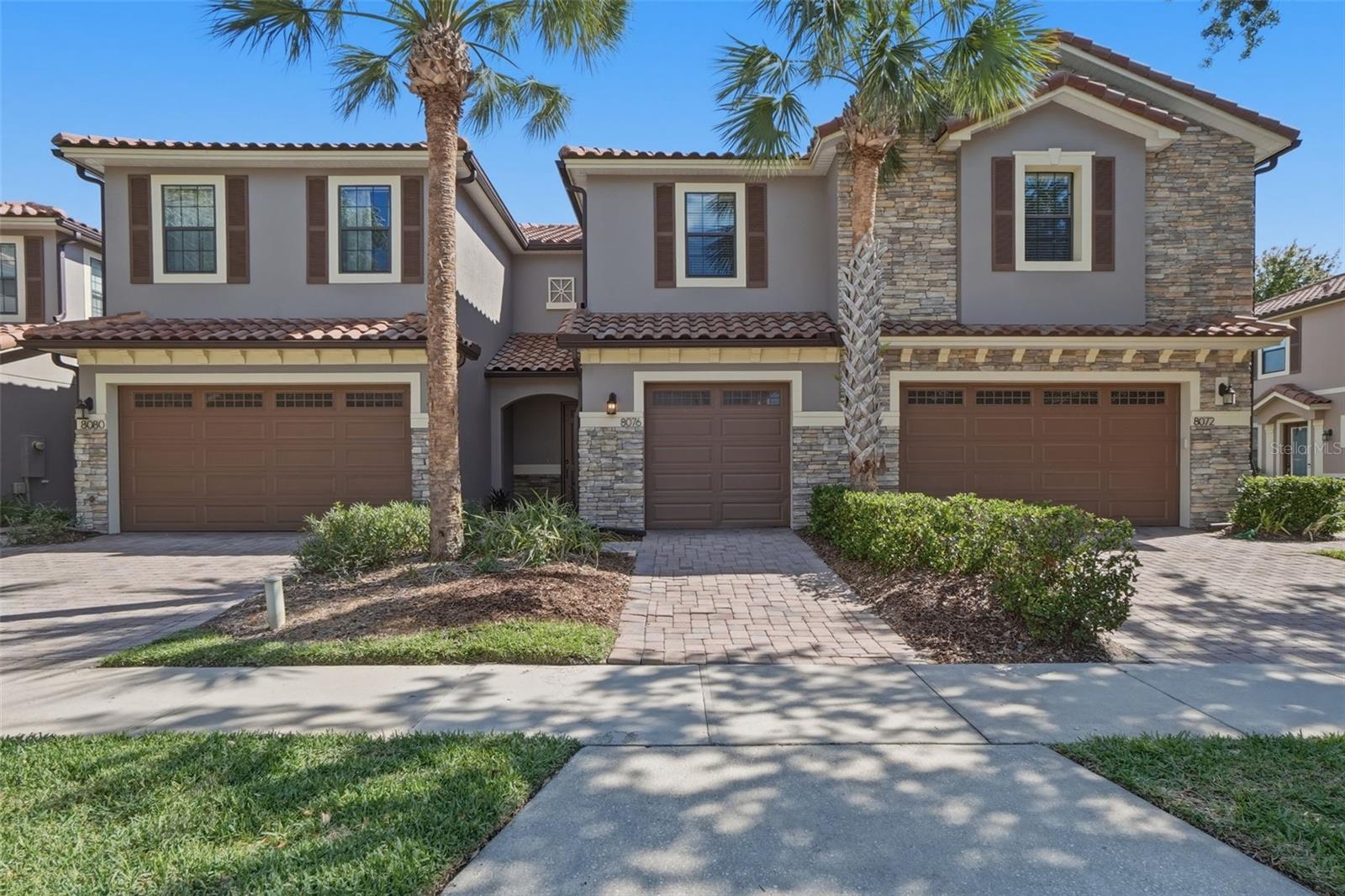 Welcome to this beautifully maintained townhome in the highly desirable, guard-gated community of Eagle Creek in Lake Nona. This spacious two-story residence offers 3 bedrooms, 2.5 baths, and a one-car attached garage, combining comfort, style, and functionality in one of Orlando’s most sought-after neighborhoods.A charming exterior with stone accents and a covered entry creates a warm first impression. Inside, you’ll find an open-concept layout filled with natural light, featuring oversized tile flooring, recessed lighting, and a seamless flow between the living and dining areas—perfect for both everyday living and entertaining. The kitchen is thoughtfully designed with granite countertops, stainless steel appliances, rich cabinetry, pendant lighting, and a large center island that serves as the heart of the home. Sliding glass doors lead to a private, fenced paver patio with no rear neighbors, ideal for outdoor dining, grilling, or simply relaxing. and a private backyard with no rear neighbor.  Upstairs all three bedrooms are generously sized, including a spacious primary suite with tray ceiling detail, a walk-in closet, and an en suite bath featuring dual sinks, stone countertops, and a walk-in shower with modern tilework. The additional bedrooms share a well-appointed full bath, and the upstairs laundry area adds convenience to daily living.This move-in ready home offers a fantastic opportunity for both homeowners and investors. Residents of Eagle Creek enjoy access to an impressive array of amenities, including a championship golf course, resort-style pools, clubhouse, fitness center, tennis and basketball courts, playgrounds, and scenic walking trails—all within a 24-hour guard-gated community.Ideally located in the heart of Lake Nona, just minutes from Medical City, top-rated schools, shopping, dining, major highways, and Orlando International Airport, this home delivers the perfect blend of lifestyle, location, and long-term value.
