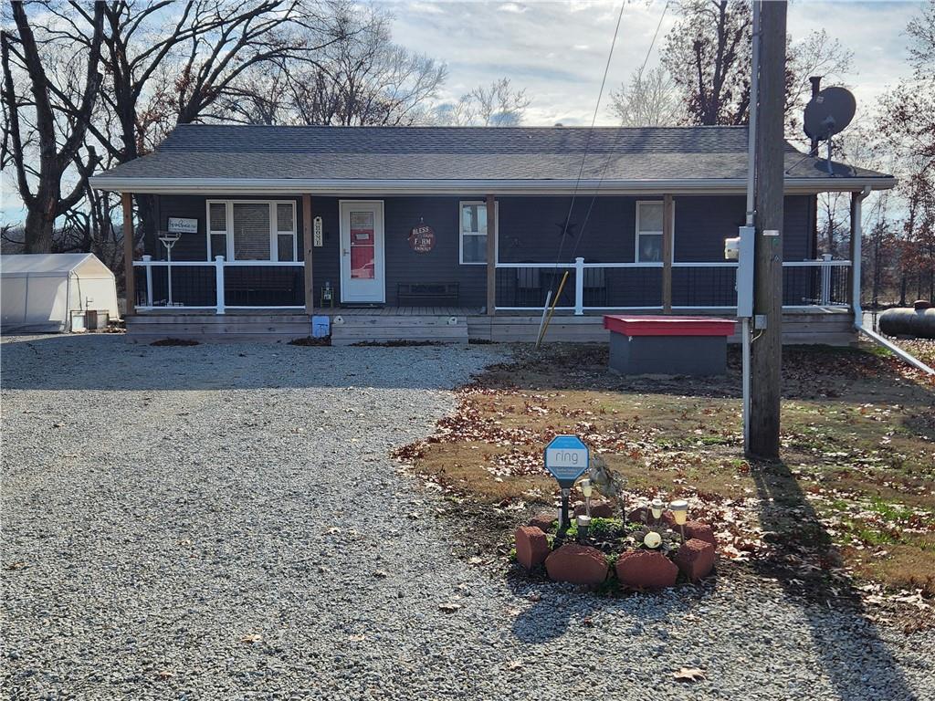 Private Country Oasis on 2 Acres. Escape to your own private oasis on this beautiful, fully fenced 2-acre property, perfectly nestled and surrounded by quiet farmland for ultimate privacy, all while enjoying the picturesque, maintenance-free view of the neighbor's pond. The house itself was extensively remodeled in 2021 and feels like new, featuring an inviting open-concept living room and kitchen where light pours in from both sides, creating a bright and lovely space for reading or cooking, complete with a granite-topped island. Currently configured with three full baths and a unique main bedroom suite upstairs (formed by combining two bedrooms by removing a closet, which can easily be put back to restore three conforming bedrooms). This home is efficiently heated by a gas furnace upstairs and wood-burning stove used to warm the lower level. You'll find a covered front porch and a generous deck out back leading to the 18-foot round above-ground pool, ideal for enjoying the country views; the walkout lower level adds immense value, featuring a laundry room/full bath combo, a nice-sized family room, two non-conforming bedrooms, and still plenty of storage area. Outside, the 2-acre lot is fully equipped with amenities, including a barn with two distinct work areas, a double carport, and a greenhouse perfect for growing flowers and vegetables. Come see, fall in love, and make this meticulously maintained country retreat your next place to call home....  Ask about the Furniture. Almost everything is for sell, inside and out including the gazebo!