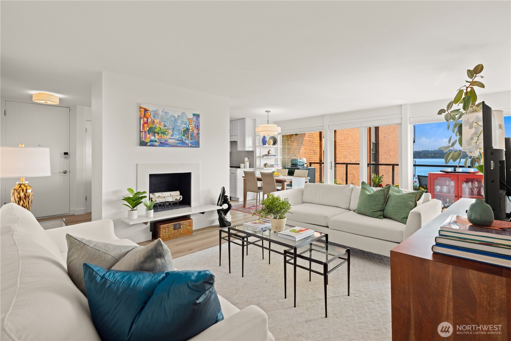 Experience elevated lakefront living in this beautifully remodeled Madison Park condo overlooking the serene waters of Lake Washington. Thoughtfully renovated from top to bottom, this move-in ready home features all new luxury vinyl plank flooring throughout, two fully remodeled bathrooms and a stunning new kitchen designed for both everyday living and entertaining. The kitchen showcases quartz countertops, new cabinetry with abundant storage, and a spacious island that serves as the centerpiece of the open-concept living area. The guest bedroom is complete with a Murphy bed, offering flexibility for hosting overnight guests, creating a home office, or accommodating everyday living. Enjoy beautiful views of Lake Washington and Mt. Rainier from the comfort of your own home, along with the convenience of one dedicated parking space, a private storage unit, access to the community dock and gym. Ideally situated along the waterfront and just a short stroll to the shops, restaurants, cafés, and parks of Madison Park Village.  This is a rare opportunity to enjoy the very best of Madison Park living.