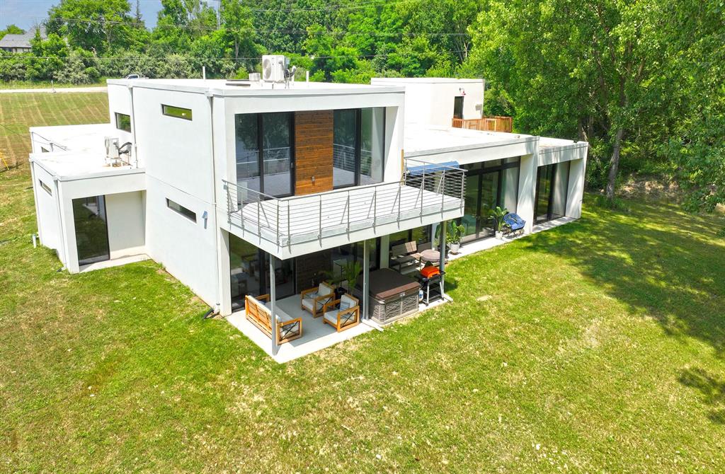 The BENEFIT of this AA property... amazing details follow...The BENEFIT of this spectacular lakefront custom-designed home built with ALUPROF Triple pane Passive House certified (European and American standards).... First the basics: 4 to 5 Bedrooms, Master Suite, In-Law Suite, Ensuites, 4 Full Bathrooms, 1 Half Bathroom, OVER 3 Acres, direct private waterfront, Oversized 2 Car Garage, nearly 4,000 square feet of stellar finished space, Ann Arbor Schools, Ann Arbor Mailing, open concept modern style.  Now the spectacular stuff... Air tightness to passive house level, Potential NETZERO and LEED Platinum certification, Ultra high R-value (30/60/90) insulation, Designed to take direct sunlight to heat the concrete and marble slab of the house during the winter months.  And there is so much more... All Steel Framing, Guardian wall panels - Structural insulated panels set in steel studs, Structural foam - 2 feet under the slab / 15" thick roof and 8" walls (reinforced steel), Swiss Air handler ERV system, Aluminum windows imported from Poland, Heat pumps with individual units for bedrooms, All bathroom sinks are equipped with an instant hot water supply, Heated and insulated 30' garage with two electrical automobile chargers, Bedrooms - Outside rolling shutters, Custom-designed and handmade woodworking around the house with white oak and walnut, pantry kitchen with dishwasher and prep area, Commercial Durolast flat roof with room for expansion, Marble flooring, marble shower walls and marble kitchen backsplash, Carlyle wood flooring, very rare Japanese charred wood siding, Commercial grade Stucco, Two Electric Car Chargers, Touchless faucet with instant hot water in every faucet.  Check out the high-end appliances: 54" La-Canche oven - Handmade in France (6 figures), Gaggenau 30" Column refrigerator, Gaggenau 24" column freezer, Gaggenau 24" column wine cooler, Bosch built-in expresso maker, Two dishwashers (Bosch and Gaggenau), Drawer microwave.  Additional OPTIONS: Heated front and back patios, Wired for Savant Syst