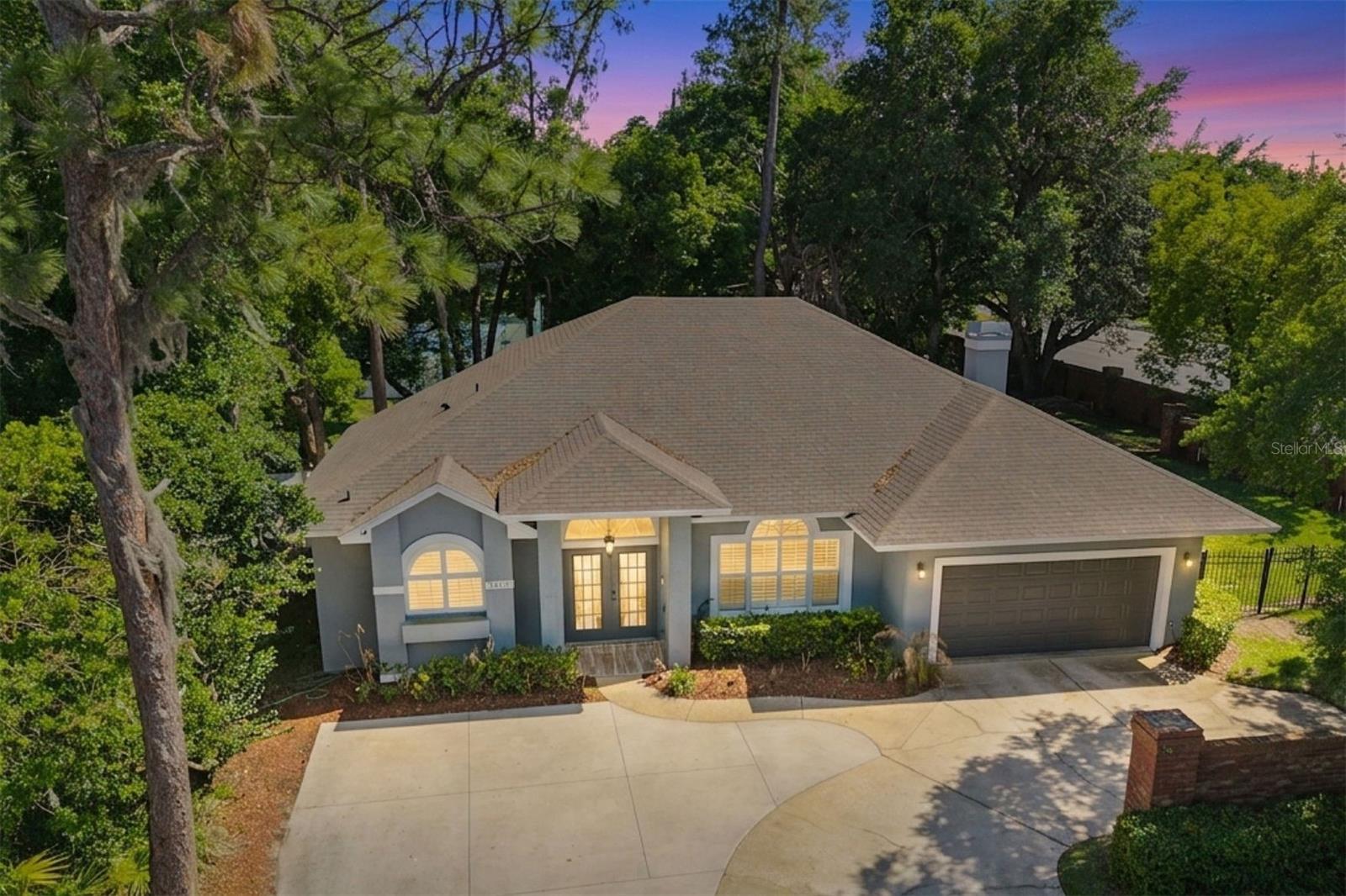 One or more photo(s) has been virtually staged. Set in the established Bay Vista Estates community in the heart of Doctor Phillips, this fully renovated 3-bed, 2-bath home offers the kind of thoughtful upgrades, flexible space, and indoor-outdoor flow that's hard to find at this price point. With quick access to major roads, everything you love about this area is right at your fingertips, from Restaurant Row to top-rated schools, shopping, and Orlando's world-class attractions. Step inside and the home immediately opens up around you. Ten-foot ceilings, wide-plank wood-look Italian porcelain tile, and detailed double-crown molding create a clean, modern vibe that still feels warm and inviting. Plantation shutters adorn the windows, adding a custom-tailored look to the interior. The split floor plan gives everyone their own space, while the main living areas naturally bring people together. The flexible floor plan allows a combination of formal living and dining spaces, a home office space overlooking the front drive, or a hobby space or art studio bathed in natural light. The kitchen is where the home really comes alive. It's designed for real life functionality, not just for appearance. Custom double-stacked cabinetry with interior lighting, exotic granite countertops, high-end stainless-steel appliances, and a farmhouse sink anchor the space, while the oversized island invites everything from casual breakfasts to weekend gatherings with friends. It overlooks the family room, where a wood-burning fireplace and built-in surround sound make it just as suited for a relaxed night in as it is for entertaining. The owner’s suite offers a true sanctuary to recharge at the end of the day. Cool and dimly lit for serenity, the natural wood-look tile flooring adds warmth, while the renovated bathroom feels fresh and elevated with dual sinks, a walk-in shower, and a jetted soaking tub that makes it easy to slow down and unwind. Then you step outside, and the Florida lifestyle unfolds before you. The screened-in patio stretches out with over 1,200 square feet of brick-paved space, creating a setting that is ready for everything from game days to family celebrations. With pre-wiring for an outdoor TV, built-in audio, and plenty of room to spread out, it becomes a natural extension of the home. The fully fenced backyard offers tree-shaded privacy with no rear neighbors and community amenities just steps away, giving you your own space to enjoy the outdoors in a way that feels both open and comfortable. Everywhere you look, the care and investment in this home stand out. From the newer HVAC system and updated ductwork to the fencing, new electric panel and electric vehicle charger, extended driveway, and more than $100,000 in improvements, the work has already been done so you can simply move in and start enjoying it. With all hard-surface flooring, there is no carpeting to maintain, making it ideal for pets, children, and holiday gatherings. Living in Bay Vista Estates also means access to the Sand Lake Chain through the community boat ramp, along with tennis, basketball, and pickleball courts. It is a neighborhood where weekends can be as active or relaxed as you want them to be. This is the kind of home that perfectly fits different stages of life. Whether you are buying your first home, downsizing to something easier to maintain, or looking for an updated single-story home in one of Orlando's most desirable areas, this house offers the rare and desirable balance of features you've been seeking.