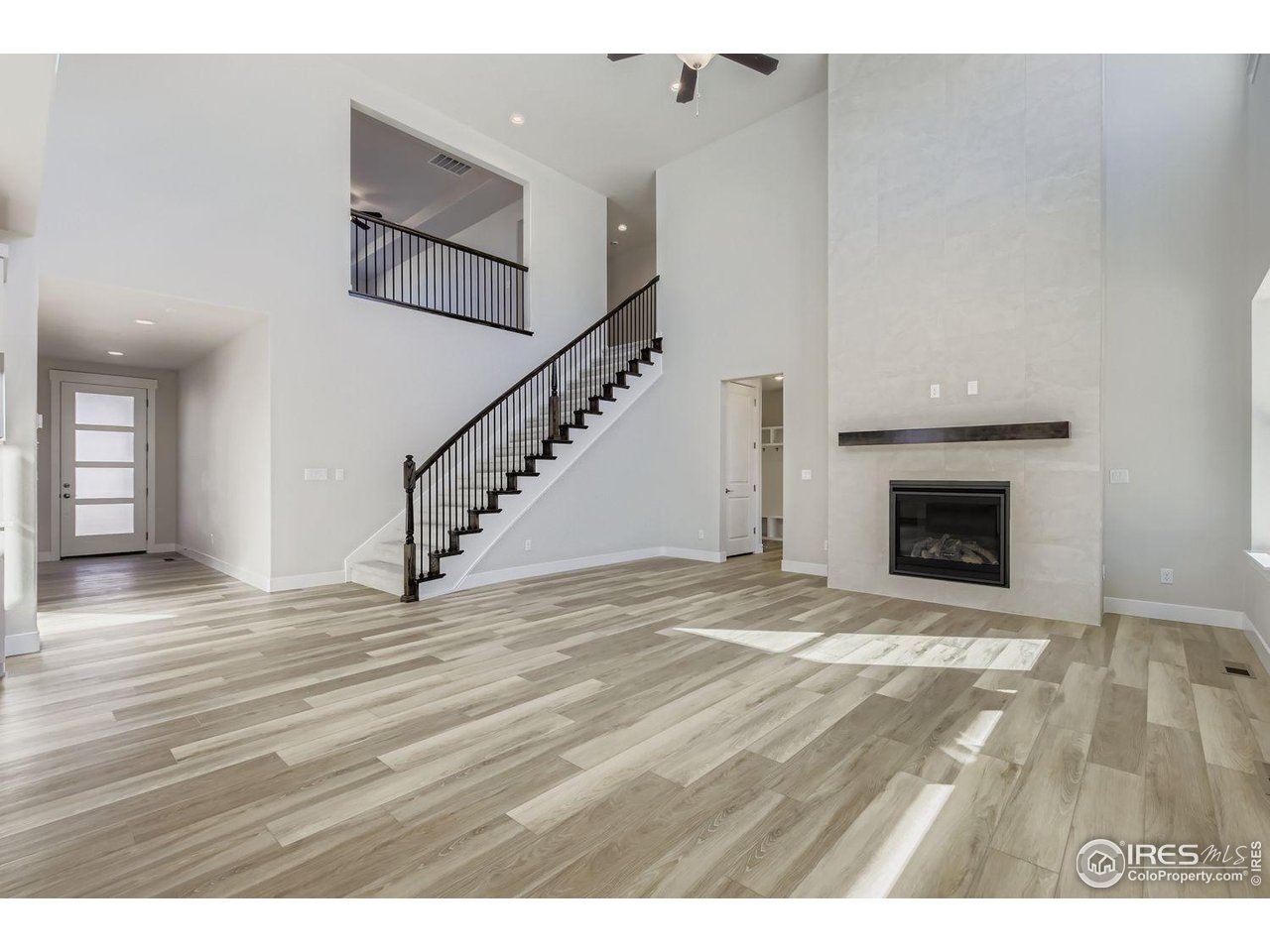 As you enter the spacious foyer with high ceilings, you will find a study tucked to one side. Continue into the open concept dining room, kitchen, and family room with a two-story fireplace. Enjoy impressive features in the gourmet kitchen with built-in double ovens, 36" gas cooktop, under mount sink, 3cm Quartz countertops on the large kitchen island, 42" soft close cabinets with under cabinet lighting. Enter the main level en suite through a private entry off the mudroom. This first floor bedroom is great for a guest room or multi-generational living includes a walk-in-closet and attached bath with a walk-in shower. Once upstairs you are greeted with a loft perfect for a game room or study space and laundry room. The luxury primary suite can be found upstairs and features beautiful tray ceilings and a fan. Through the double doors in the primary bedroom, enter your 5-piece luxurious bath retreat, complete with an impressive walk-in closet, double vanities, a walk-in shower and soaking tub. Upstairs, you will find an open view into the family room, a spacious game room, and two additional bedrooms with walk-closets and Jack-n-Jill style bathroom. There is plenty of room for the whole family in this American Legend Home. Head outside to your outdoor living - perfect for outdoor entertaining. Located steps away from the RainDance National Golf Course in Sugar Hills.
