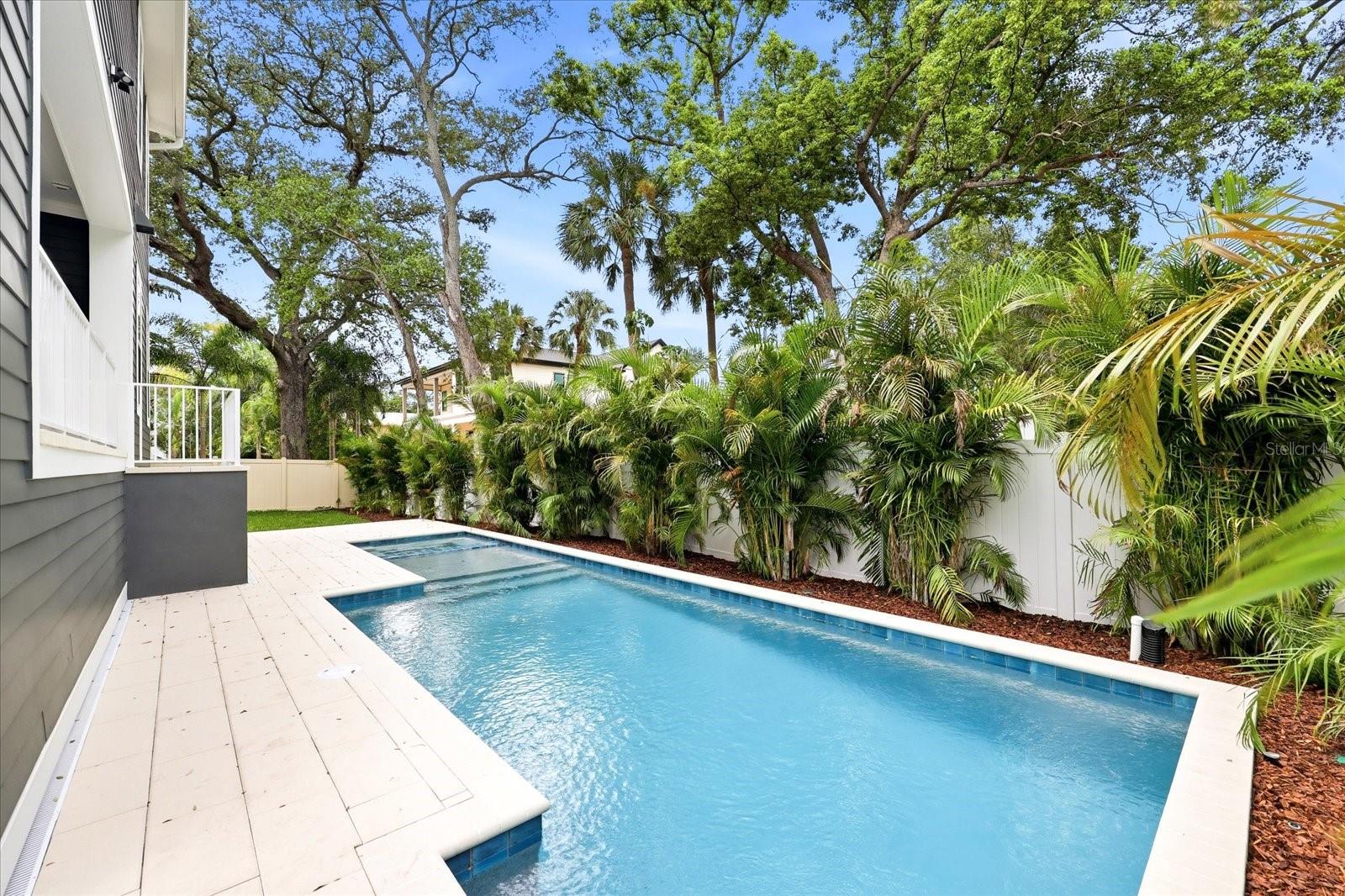 NEW CONSTRUCTION. In the heart of coveted Maryland Manor, one of South Tampa’s most sought-after neighborhoods, this exceptional new construction residence offers the rare opportunity to secure a luxury home with exceptional finishes to compliment your extraordinary lifestyle.Thoughtfully designed for the discerning buyer, this custom-built residence seamlessly blends timeless architecture with elevated modern living, showcasing impeccable craftsmanship and the uncompromising quality of a premier luxury builder known for exceptional attention to detail and superior construction standards. This home is centered around an extraordinary indoor-outdoor living experience offering an expansive COVERED lanai with a fabulous summer kitchen, and seamless indoor-outdoor flow designed for year-round enjoyment and effortless entertaining.Inside, the chef’s kitchen serves as the heart of the home, featuring bespoke cabinetry, premium Fisher & Paykel appliances to include a 48"  GAS RANGE with DOUBLE OVEN, DOUBLE DRAWER DISHWASHER,  exceptional 30" refrigerator, 30" freezer, COFFEE BAR, POT FILLER, an OVERSIZED island, and refined finishes curated for both beauty and function. Sun-drenched interiors are enhanced by abundant natural light, soaring ceilings, and thoughtfully placed windows that create warmth, openness, and a true sense of serenity.Each of the FIVE SPACIOUS bedrooms offers its own en-suite bath, providing exceptional privacy and comfort for both family and guests. Every detail has been intentionally selected to deliver a sophisticated yet livable design that feels both luxurious and welcoming. Luxury-forward design features include SPRAY FOAM insulation, 25 Seer Carrier Infinity HVAC, Kohler WHOLE HOUSE GENERATOR (26kw air-cooled), pre-wiring and structural readiness for future elevator installation. Home automation package with cameras included, Hardie Board siding, Meon Flo leak prevention system, and level 5 drywall finish. Beyond it's stunning design, this home boasts exceptional livability with a 3-car garage pre-wired for an electric car charger, DOUBLE WASHER AND DRYER set-up in laundry room, gracious covered front porch, OVERSIZED side yard, and extensive storage. This is more than new construction—it is a rare opportunity to secure a statement home in one of Tampa’s most desirable locations where design and craftsmanship come together to create something truly exceptional. Don't miss watching the video with some "AI generated enhancements" cooking in the kitchen and playing in the yard!
