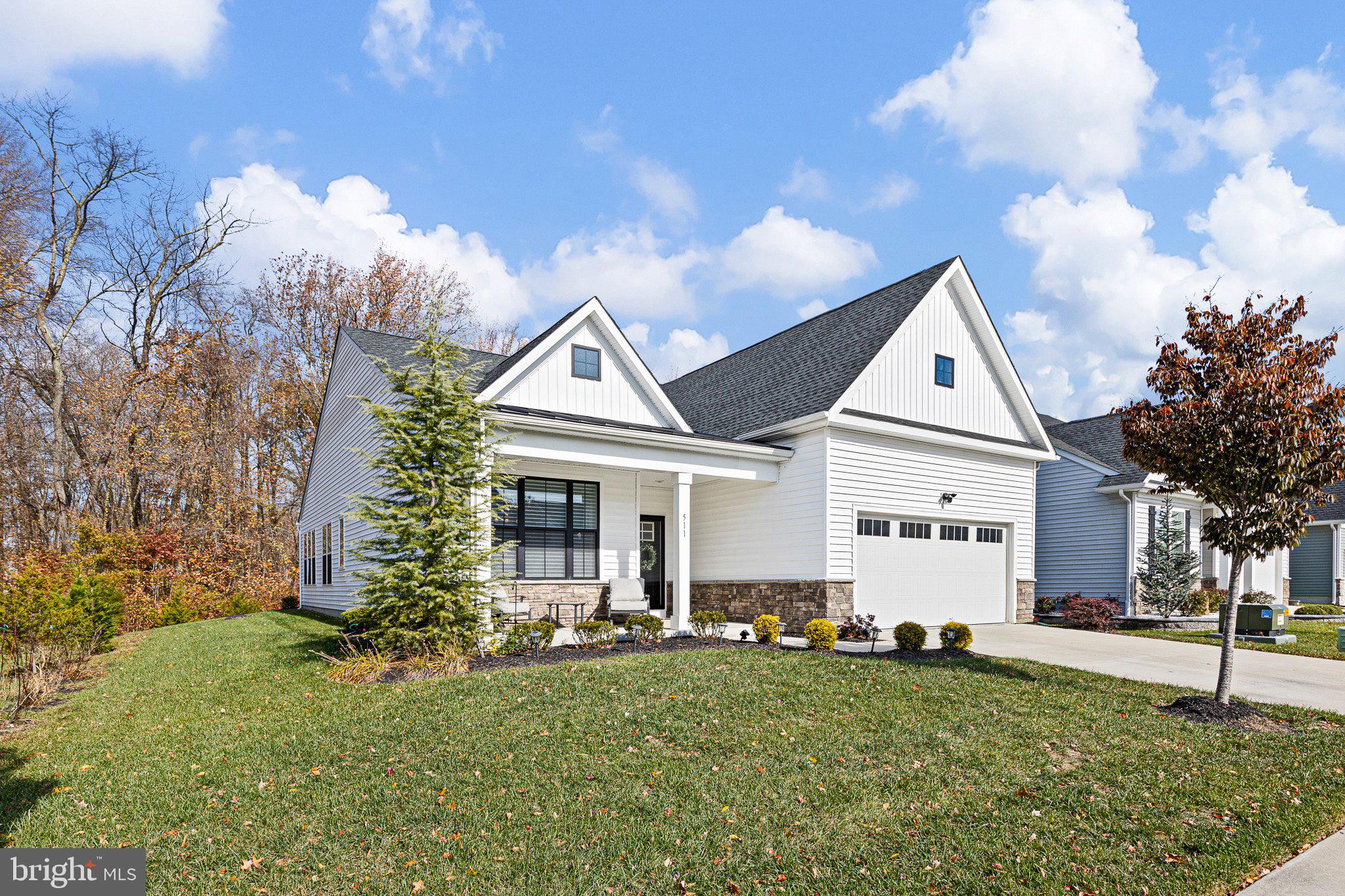 Welcome home to 511 Davis Falls Drive, a stunning 2 Bedroom, 2 Bath residence in The Cascades, Newark’s premier 55+ active adult community. Offering low-maintenance living and resort-style amenities—including a clubhouse, fitness center, and seasonal outdoor pool—this home combines comfort, style, and convenience in one perfect package.The charming farmhouse-style exterior and welcoming front porch set the tone for the thoughtfully designed interior where everything you need is on the first floor. Step inside to find an open-concept layout with 9-foot ceilings and abundant natural light. The gourmet kitchen features upgraded 42" white cabinetry, subway tile backsplash, quartz countertops, a large island with seating, and a stainless steel appliance package with gas cooking. The kitchen flows seamlessly into the dining area and family room, complete with a cozy fireplace.French doors open to a bright rear sunroom with shiplap accents, overlooking open space and mature trees—a peaceful retreat perfect for morning coffee or evening relaxation. The flex/living room off the foyer adds even more versatility for entertaining or quiet reading.The expansive primary suite is a private oasis featuring a tray ceiling, two generous walk-in closets, and a spa-inspired bath with double-bowl vanity and an oversized tile shower with bench. A second bedroom and full bath provide comfortable accommodations for guests.Additional highlights include:Spacious 2-car garage, partially attic above garage with convenient stair access (ideal for storage, a home office, studio, or hobby room), Lennox HVAC system and tankless water heater for energy efficiency, and the beautiful window treatments are includedEnjoy The Cascades’ easy-care lifestyle with lawn maintenance and snow removal included, plus easy access to major roads, shopping, restaurants, and nearby Glasgow Park.511 Davis Falls Drive — A beautiful blend of luxury, comfort, and convenience in Newark’s sought-after 55+ community.