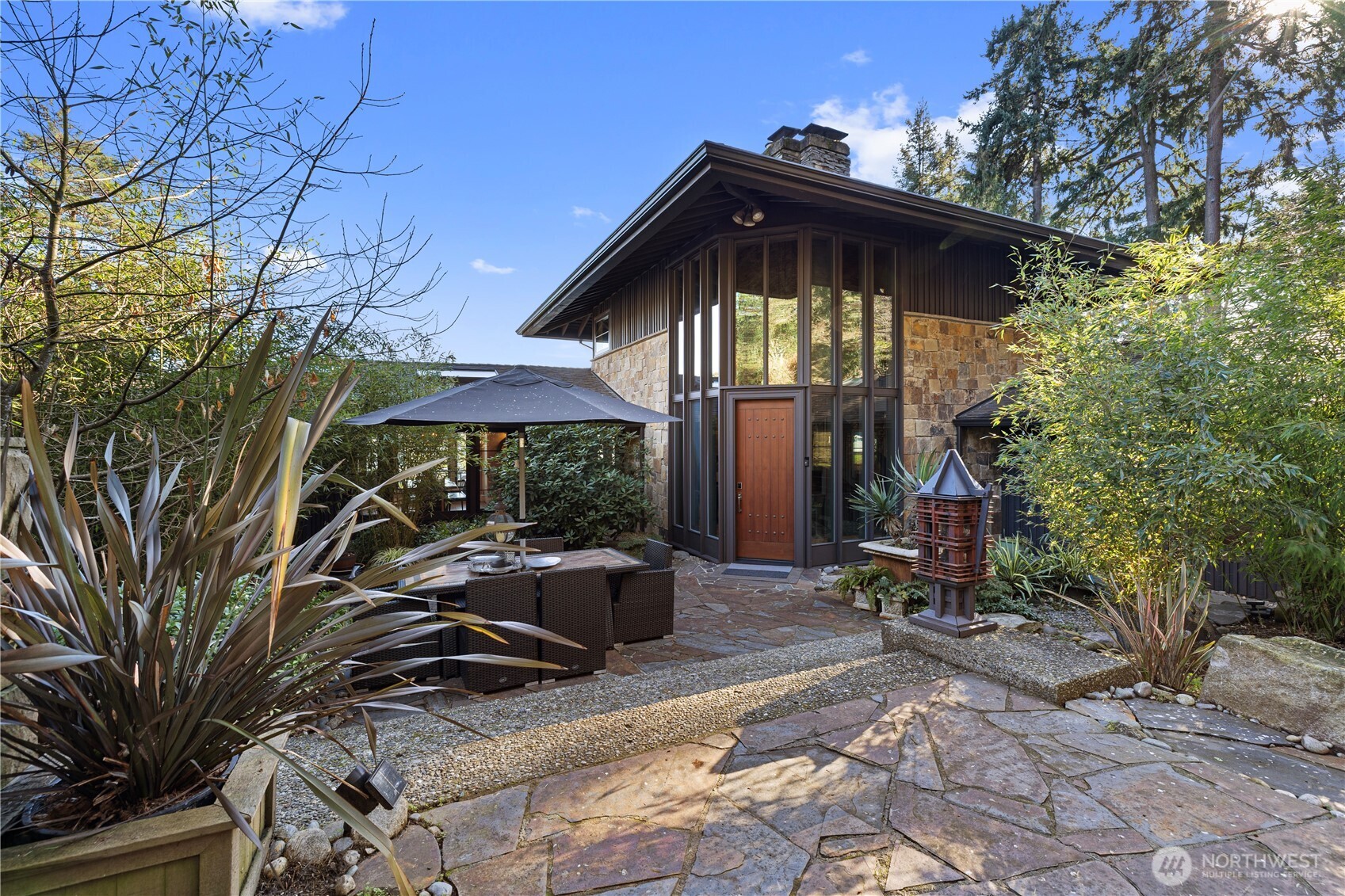 Originally designed by Ralph Anderson, the pioneering father of Pacific Northwest architecture and a protégé of Frank Lloyd Wright, this exceptional residence reflects a philosophy that moves beyond rigid, box-like forms. Embracing an elongated, open, and nature-driven architectural language, the design creates a seamless visual and spatial flow between interior and exterior living. The L-shaped layout is thoughtfully integrated into the site, unfolding with elegance while maximizing panoramic views of Lake Washington, surrounding mountains, and serene woodland. Semi-enclosed courtyards and layered garden spaces draw from both Eastern and Western design traditions, creating ever-changing vistas and a sense of movement throughout the home. With virtually no visual dead ends, every space offers a carefully framed connection to nature. Renovated in 2022, the home preserves its original architectural integrity while incorporating contemporary design elements and modern comforts, perfectly suited to today’s lifestyle. 1/5 share 50’ beautiful, sunlit wade-in beach with designated moorage.