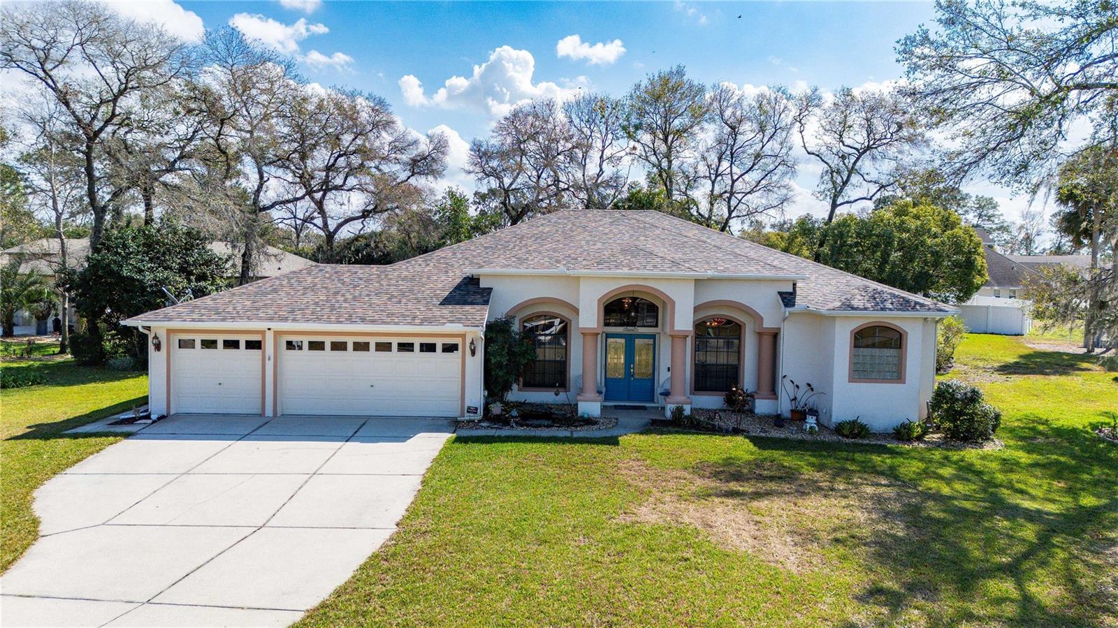 Step into your private oasis in Plantation Estates! Set on a spacious corner lot, this exceptional home blends elegance and comfort with 3 bedrooms, 2 bathrooms, and 2,115 square feet of beautifully designed living space. Step through the grand double doors to soaring ceilings and a thoughtfully designed split floor plan. The great room, highlighted by tray ceilings, creates a warm, inviting atmosphere. A formal dining room and cozy breakfast nook offer versatility for entertaining or everyday life, while a dedicated home office ensures productivity and privacy. The kitchen is a chef's dream, featuring updated appliances, sleek Corian countertops, and ample cabinetry. Unwind in the luxurious primary suite, complete with two spacious walk-in closets and a spa-like en suite bathroom with a soaking tub, dual sinks, and a large walk-in shower.Outdoor living is just as impressive. Relax on the screened lanai, take a dip in the sparkling pool, or enjoy the lush, park-like backyard with a well irrigation system and an additional storage shed for convenience. A spacious 3-car garage, complete with a water softener and filtration system, adds the finishing touch. Located in a sought-after community with easy access to shopping, dining, and entertainment, this home is a rare find. Enjoy added peace of mind with a new roof (2022) and a newer HVAC system. Don't miss your chance to own this stunning property; schedule a showing today!