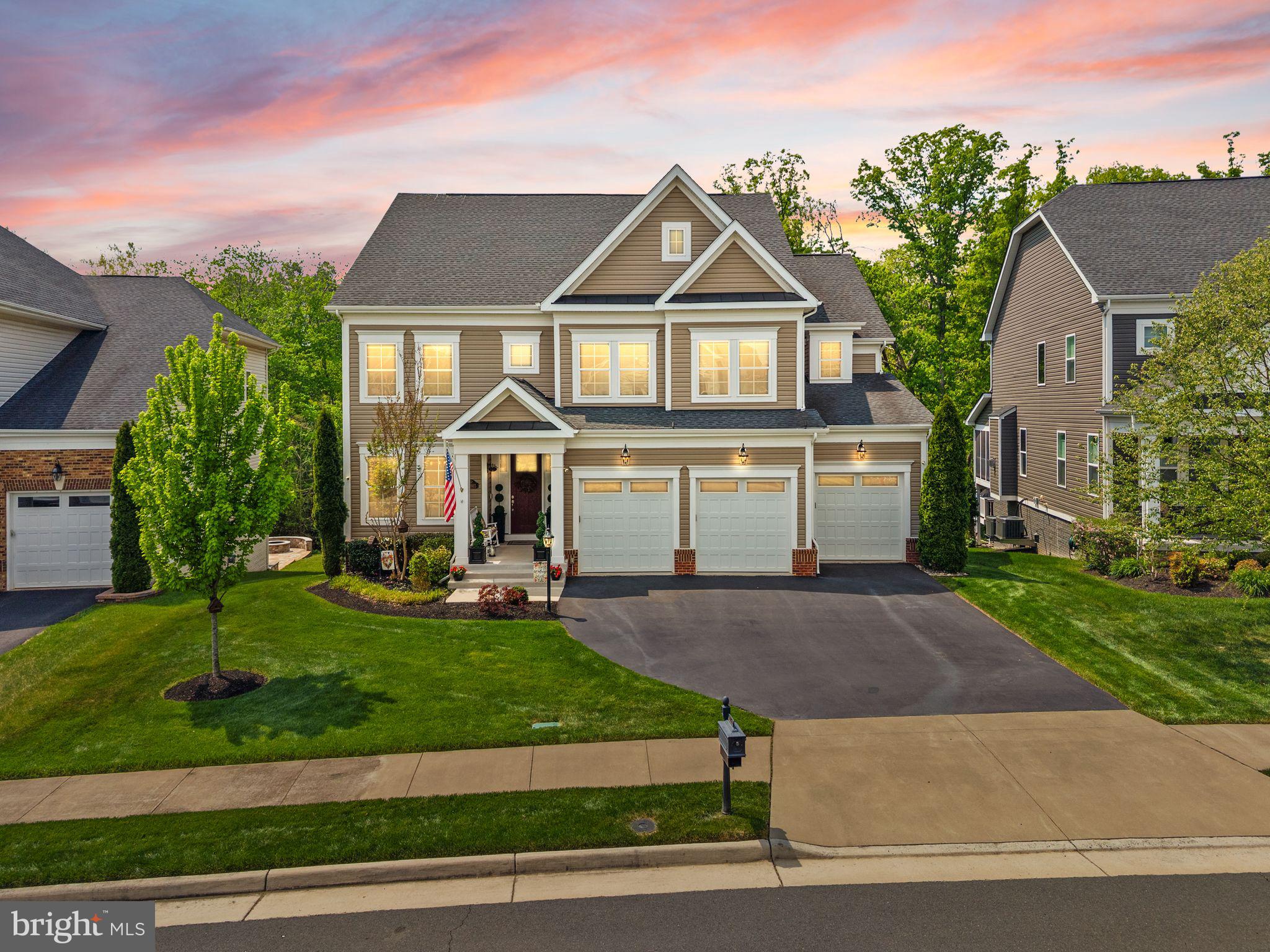 Elevated Living in Westbury Glen. Built in 2018 and now offered for the first time by its original owners, this meticulously maintained five-bedroom residence offers three floors of generous, sunlit living space with extensive upgrades throughout, a private wooded lot backing to trees, and multi-level outdoor entertaining, all in the heart of Loudoun County. Step inside to a light-filled foyer and formal dining room, with an open layout designed equally for entertaining and everyday comfort. Hardwood floors and elegant moldings carry through the main level. The grand two-story great room is wired for surround sound and centered on a floor-to-ceiling gas fireplace. The gourmet kitchen pairs all-white cabinetry with rich quartz countertops, a tile backsplash, stainless steel appliances including double ovens, and abundant storage with two walk-in pantries. A large center island invites casual meals and conversation, while the breakfast room opens through sliding doors to the deck for effortless grilling and outdoor gatherings. A main-level office and powder room complete this floor. Upstairs, the luxurious primary suite features tall tray ceilings, a sunny sitting area overlooking tranquil tree views, and a huge double-sided walk-in closet with passthrough access to the upstairs laundry. The primary bath includes double vanities, a soaking tub, and a spacious shower. Also on this level is a junior suite with its own full bath, plus two additional bedrooms sharing a Jack-and-Jill bathroom with double sinks. Every bedroom enjoys great natural light and storage. The finished, daylight lower level walks out directly to the patio and offers a spacious recreation room with full-size windows, recessed lighting, a fifth bedroom with a full bath for a private guest suite, rough-in plumbing for a bar, and additional unfinished storage. Outside, the two-level deck creates an impressive backdrop for outdoor living, where a secluded hot tub sits tucked away for privacy. A stamped concrete patio with a fire pit extends the entertaining space further, all set against the wooded backdrop. An inground sprinkler system and professional landscaping with uplighting enhance the grounds. Notable upgrades include a three-floor bumpout for added space, 400-amp breaker box, whole-home humidifier and upgraded HVAC filtration, alarm security system, tinted windows with blackout blinds, upgraded carpet and padding, Ethernet hardwired throughout with three wireless access points (one per level), a Taexx pest control system, and the three-car garage. Conveniently located with easy access to Route 50, I-66, Route 15, Route 28, Dulles Toll Road, and Dulles International Airport. Top-rated schools, dining, shopping, wineries, golf courses, parks, and breweries are all just minutes away. This is a home where every detail has been considered, and it shows.