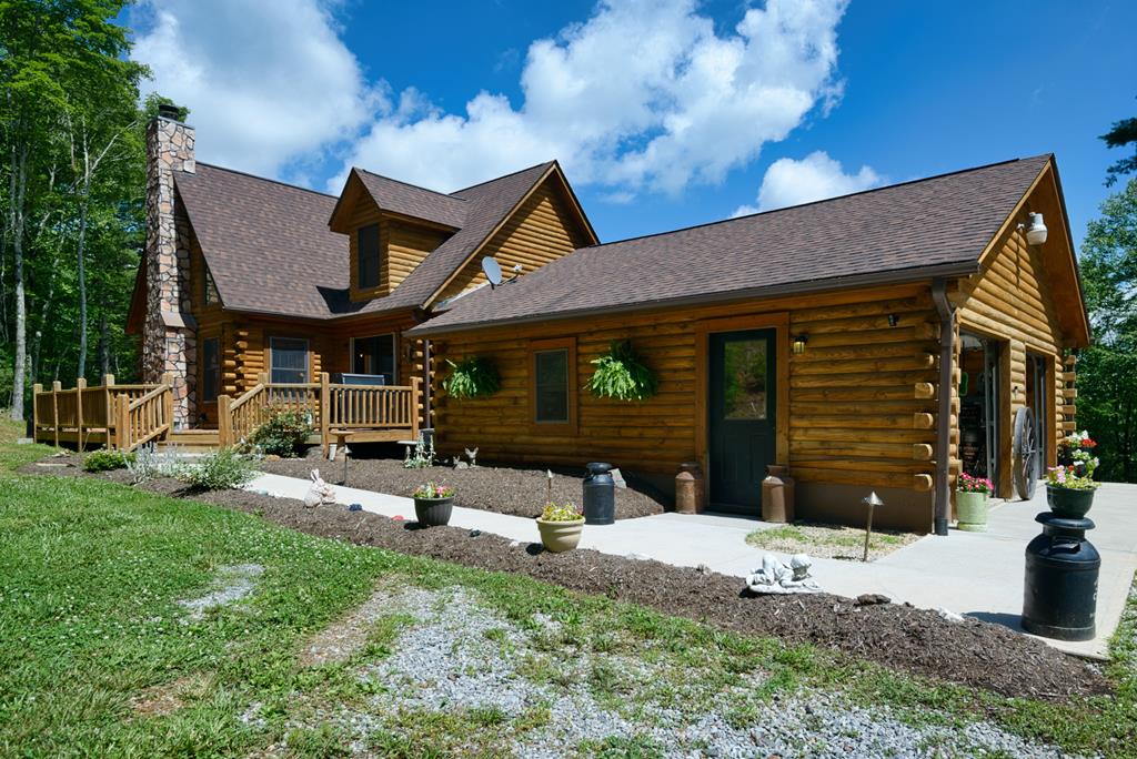 Luxurious, treasured log home on 13+ partially wooded acres! Views of Buffalo Mtn from covered front porch in the Fall/Winter months, gather for cookouts on wrap around deck & end the days relaxing around the firepit. Main level entrance from 2-car garage thru breezeway &relax in vaulted great room w/ multitude of windows for natural light & wood burning fireplace to cozy by in the winter. Primary bedroom w/ walk-in closet on main level w/ custom tiled shower. Additional 2 bedrooms upstairs have plenty of creative storage space. Pine floors & custom features throughout including a built-in china cabinet from an old farmhouse & a piece of Cambria history adorns the wet bar with a moonshine barrel from the Country Store of a local famous photographer, Earl Palmer. Custom made chicken coop in yard complete with cameras, solar electricity, heat and fans. The unfinished walk-out bsmt can be finished and half bath is plumbed for a full bath. Whole house generator included!
