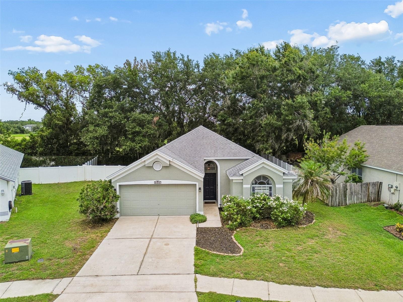 If you’re looking for an affordable Wesley Chapel home in a prime location, 6312 Ashfield Place fits the bill.  This 3-bedroom, 2 bath home has vaulted ceilings throughout lending an open, spacious feeling.  Combined with the large windows overlooking the backyard and pasture beyond, light and bright is a perfect description.  The sunlight coming through these windows is the perfect complement for your morning coffee.  The kitchen has plenty of counter space featuring a unique double island layout with quartz counters and updated tile flooring and space for a table.  Both bathrooms have been updated as well with a beautiful herringbone pattern tile.  Engineered hardwood flows from the front door through the dining room and into the living room.  Here, the tall windows are the star of the show as you look out onto the fully fenced back yard.  The lot is a little larger than most as it sits just on the edge of a cul-de-sac, fanning out in the back creating a large private space for pets, a garden, or whatever.  Let’s talk value:  the HVAC and roof were both replaced in 2020 and the exterior was painted that same year.  There’s no CDD - if you know, this is a rarity for Wesley Chapel - and the HOA fee is merely $370 for the year.  Affordability is the key word here.  And the location can’t be beat as it’s just minutes from I-75, shopping at the Grove/Krate, Premium Outlet Mall, etc, dining (with 80+ options within 10 minutes), medical, entertainment, and plenty more.  Everything you need is at your front door!