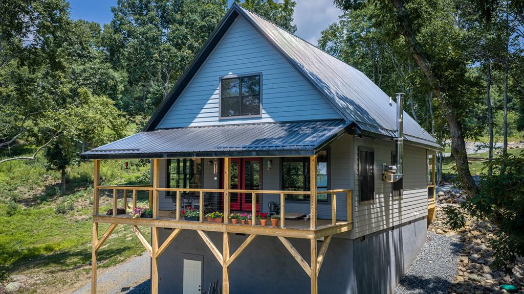 Brand New Mountain Cabin with Long Range Views! Perfect weekend getaway on 5 acres in the Point Lookout Mountain Community. There is an open concept living area with lots of large windows and doors to take in the gorgeous views and abundant wildlife. You really feel like you are in a tree house surrounded by mature trees and large rock outcroppings. The kitchen is well appointed with a large island and quality stainless steal appliances. There is a very nice pantry and laundry area. A cozy wood stove and an accent wall made from locally sourced wood highlight the living area. The primary suite has lots of closet space and bathroom with tiled shower and tub. A large open area upstairs has plumbing and electrical roughed in to easily complete a second bathroom. This could be a 3 bedroom cabin with minimal work. Cabin is has low maintenance siding and a metal roof. There are hiking trails throughout the property and the Point Lookout community has almost 300 acres of common areas with trails throughout. There are some beautiful common areas with big vistas, one just a short walk from this property and over 4 miles of paved roads with a gated entrance. This community is located just north of Independence VA, not far from the New River, Jefferson National Forest, trout fishing and all of the recreational opportunities Grayson County has to provide.