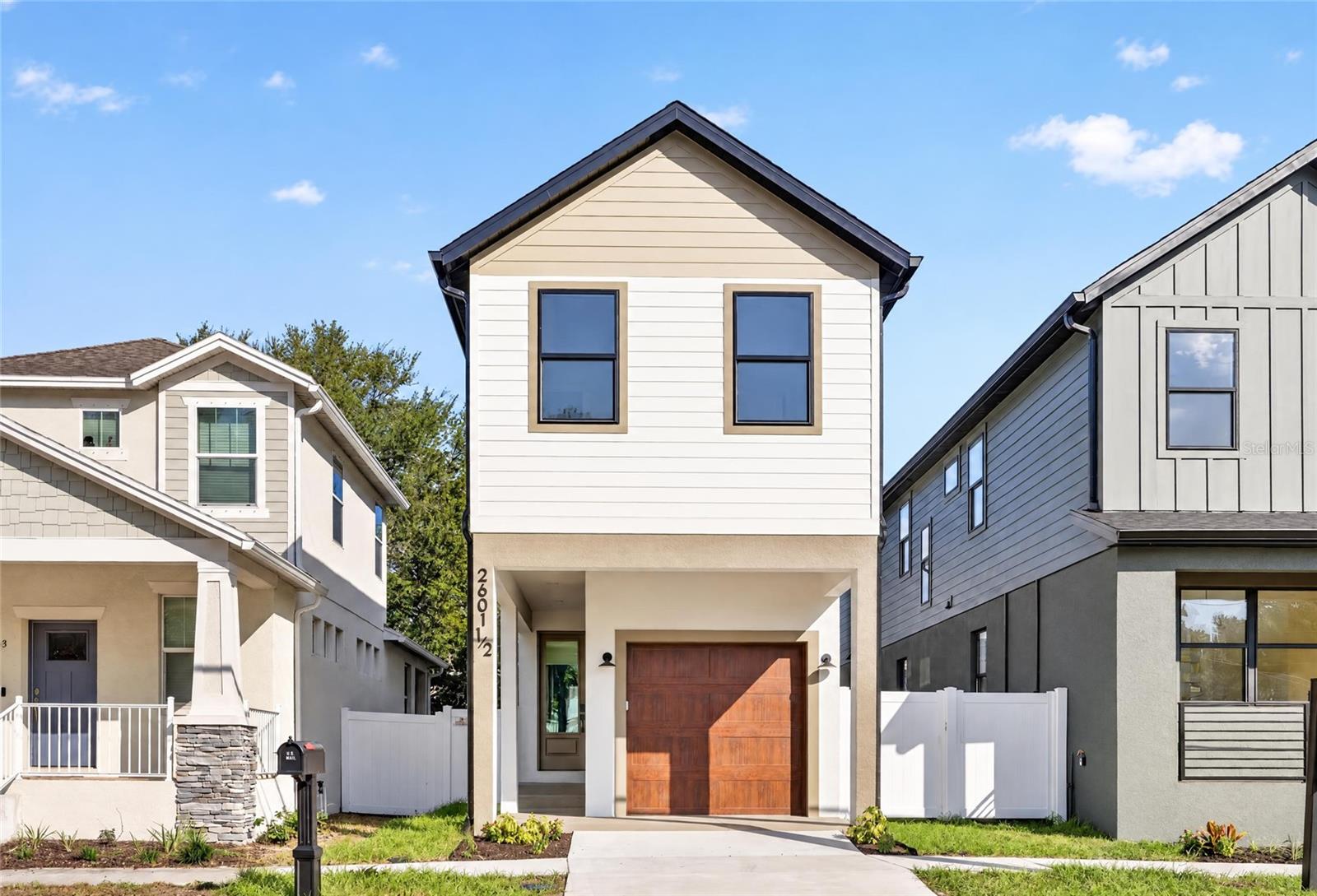 This 3-bedroom, 2.5-bathroom new construction home offers 1,565 square feet of living space on a slab foundation in Flood Zone X. Nine-foot-four ceilings on both floors, 8-foot interior and exterior impact-rated doors, and premium 10mm WPC luxury vinyl plank flooring throughout establish a quality baseline from the moment you step inside. The kitchen is built around 42" soft-close cabinetry with push-to-open doors, level 3 quartz countertops, a 6-foot white fluted island with a gold Gola rail, a Lumina 30" workstation sink, a custom vented range hood, Lumens pendant lighting, and a full Frigidaire appliance suite. Upstairs, tray ceilings accent the front and back bedrooms, while the primary suite pairs a walk-in shower with a custom built-in closet system. All bathrooms feature custom-built vanities with undermount soft-close drawers and level 3 quartz. A premium glass staircase, 6-inch flat baseboards, ceiling fans throughout, and covered front and back porches add to the finish level, and the property is fully enclosed by a white vinyl fence. Tech readiness includes Cat6 wiring to every room, a low-voltage panel, speaker pre-wire in the living room, and a smart garage door opener. Builder coverage includes a 1-year whole-home warranty, 2-year MEP warranty, and a 10-year Maverick structural warranty. Located in West Tampa, you are minutes from Downtown, the Riverwalk, Armature Works, Midtown, Raymond James Stadium, Hyde Park, Ybor City, Tampa International Airport, GasWorx, and Rome Collective. Special financing available through a preferred lender: 6.125% fixed rate (6.208% APR), no monthly PMI, and a $10,000 grant toward down payment or closing costs for eligible buyers. Offer valid through November 30, 2026.