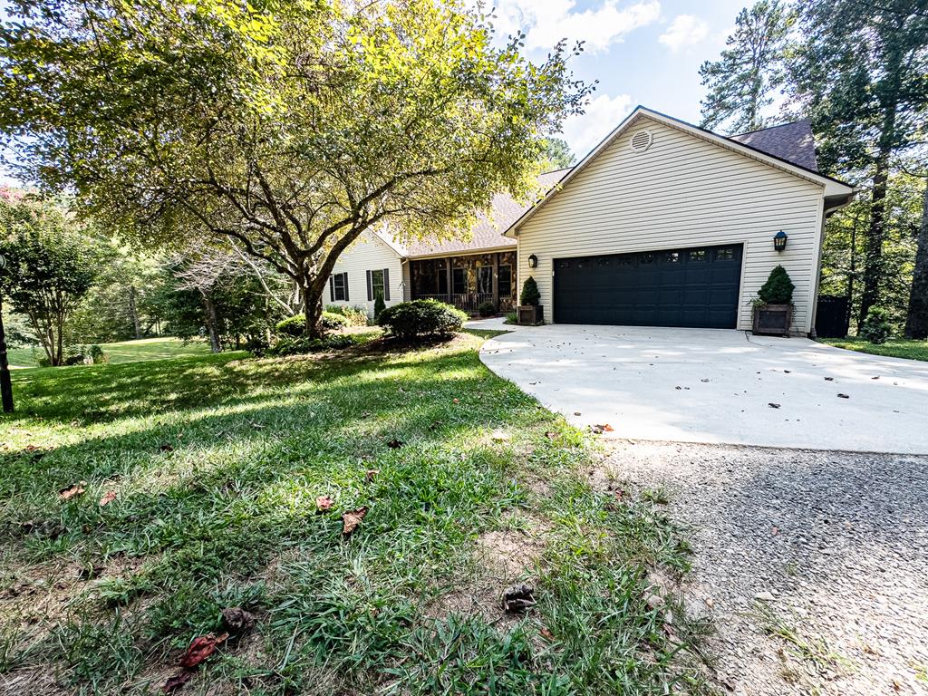 Exquisite Executive Home with Full Basement Apartment  This stunning executive home, complete with a brand-new roof in 2025, offers a rare blend of elegance, comfort, and functionality. The main floor features a welcoming entryway, a spacious great room with a floor-to-ceiling stone wood-burning fireplace, a formal dining room, and a sunny breakfast room. The kitchen is a true centerpiece with a breakfast bar, coffee/wine bar, and ample cabinet space to delight even the most dedicated cook. The primary bedroom suite is tucked into its own private wing of the house, while two guest bedrooms and an office/flex space provide plenty of room for family or visitors. Even the powder room is a work of art.  Polished wood floors, wood ceiling accents, and a thoughtful layout add to the home's appeal. The laundry room is generously sized, and the attached 2-car garage adds convenience.  Downstairs, the full in law apartment is a showstopper, featuring a drop-dead gorgeous kitchen with a walk-in pantry, dining area, and a large bedroom suite. The basement also includes abundant storage and a huge workshop space in the unfinished section.  Set on almost 4 acres, the property includes fencing for dogs, space for gardening, and a private wooded setting. Fiber optic high-speed internet keeps you connected, while the location puts you only 15 minutes from Blue Ridge, GA, and 20 minutes from Murphy, NC—both known for excellent dining, breweries, shopping, and antiques. Outdoor enthusiasts will love the nearby whitewater rafting, biking, and hiking trails.  This home is truly a rare find—luxurious, versatile, and move-in ready, with no detail left undone.
