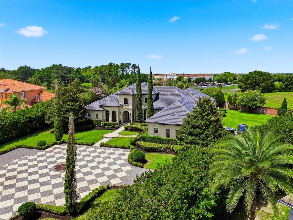 BREATHTAKING WINDERMERE ESTATE!!!  Situated on nearly 1.5 acres in the gated/guarded community of Bellaria, this custom built 4BR/4.5BA pool residence is the pinnacle of detail and design.  Follow the long drive winding amongst the towering Italian Cypress to your expansive motor court and magnificent entry.  Upon opening the massive custom double doors, you will see elegance, functionality, and breathtaking detail in every corner.  Features include:  over 5500SqFt of living area, soaring ceiling heights, top-notch molding and finish work, travertine floors, NEW carpet, NEW interior paint, massive kitchen with bar seating and island, walk-in pantry, game room with full bar and refrigeration, over 3000SqFt of rear pool and patio space with hot tub, outdoor bar/kitchen with vent fan and refrigeration, patio shower, multiple gas fireplaces, corner sliding pocket doors opening onto patio, NO REAR NEIGHBORS, gigantic privacy hedge, spacious primary suite with seating area and pool access, dual walk-in closets, exquisite primary bath with enormous soaking tub, spacious guest bedrooms and beautifully appointed  guest bathrooms, sauna, three car garage with a hydraulic lift for a fourth vehicle, generous utility room, 22kw natural gas generator installed in 2021, office with built-ins and fireplace, fully equipped theatre with elevated seating, A BRAND NEW TILE ROOF, ample storage opportunities, and the list goes on!!!  This is all just minutes from Winter Garden Village with easy access to SR429, downtown, and all the attractions!!!  Schedule your showing and prepare to be amazed, this property is special.  Call today!!!